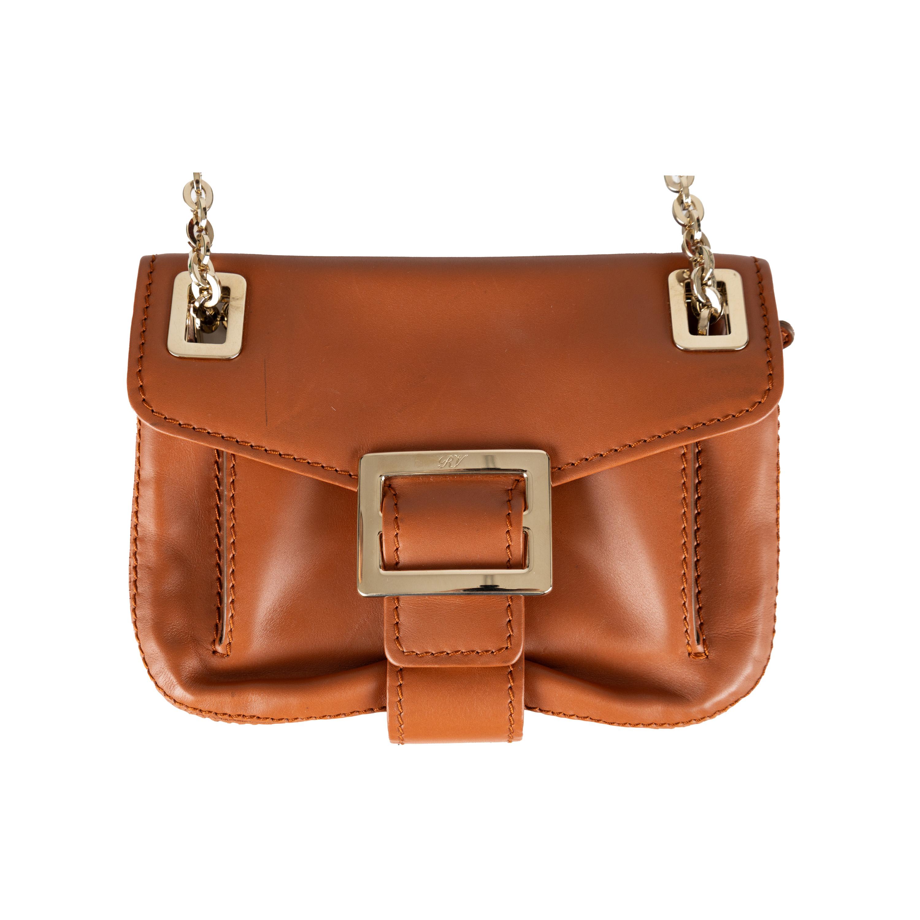 An expertly crafted essential, the Roger Vivier Metro Shoulder Bag is perfect for everyday wear. Crafted from tan brown leather, it features gold-tone hardware and plenty of room in its three interior compartments, even for its compact size. For