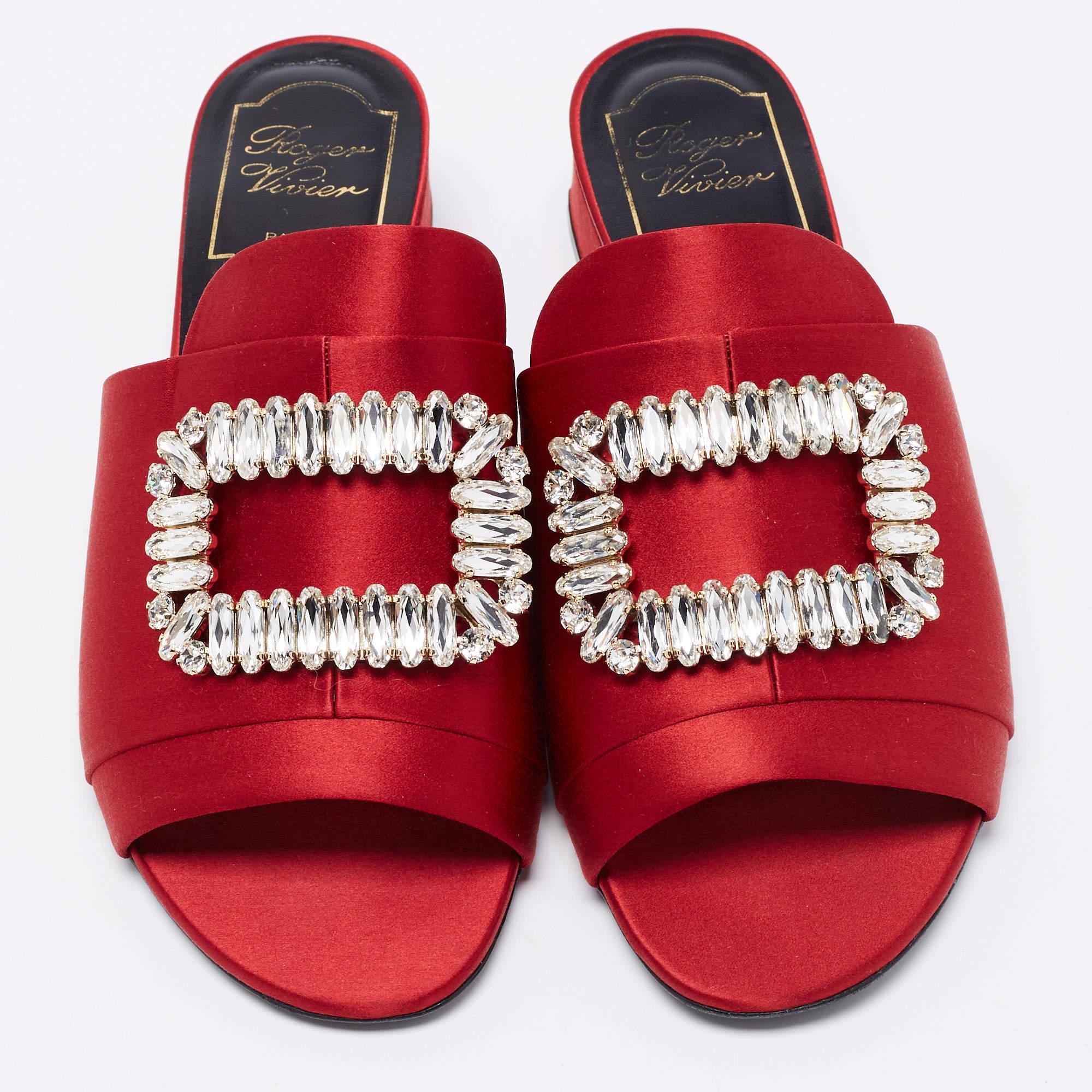 Lend your feet with complete comfort, style, and luxury with these stunning slide sandals from Roger Vivier. They are crafted using red satin, with crystal embellishments perched on the upper. They flaunt open toes, a slip-on style, and block heels.