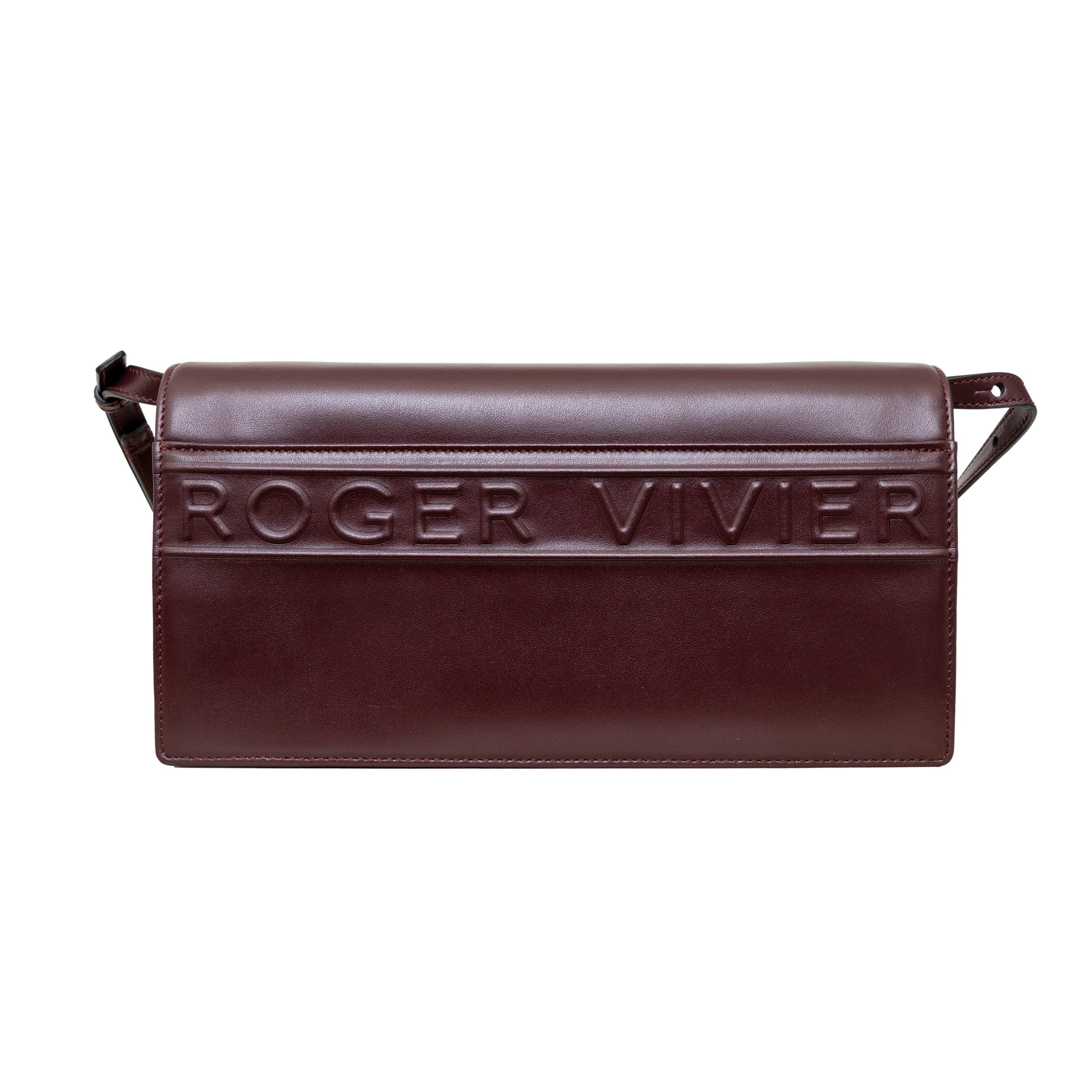 Introducing the iconic and versatile Viv' Choc Crossbody Bag from Roger Vivier. This feminine and sophisticated bag is crafted from soft dark brown leather with the signature domed buckle and letter logo on the back. Complete with a practical
