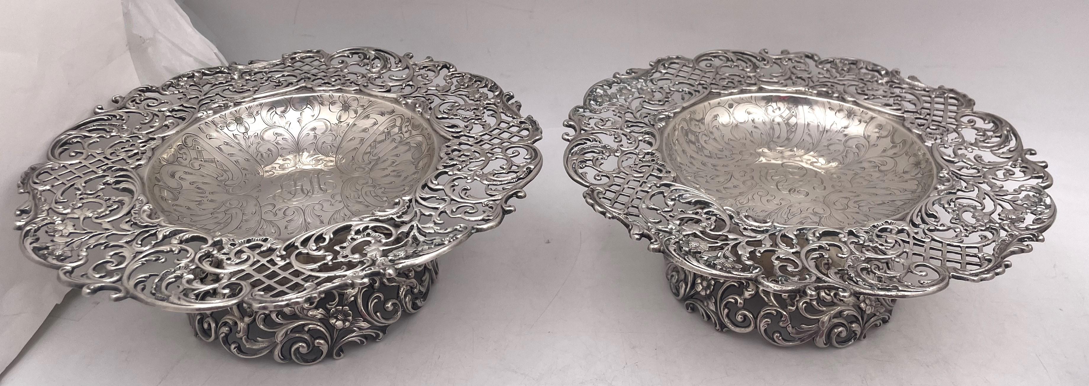 Roger Williams pair of sterling silver compote, tazze or footed bowls, from the early 20th century, in Art Nouveau style, with pierced openwork showcasing floral and curvilinear palmette motifs, beautifully engraved at the center. They measure 9