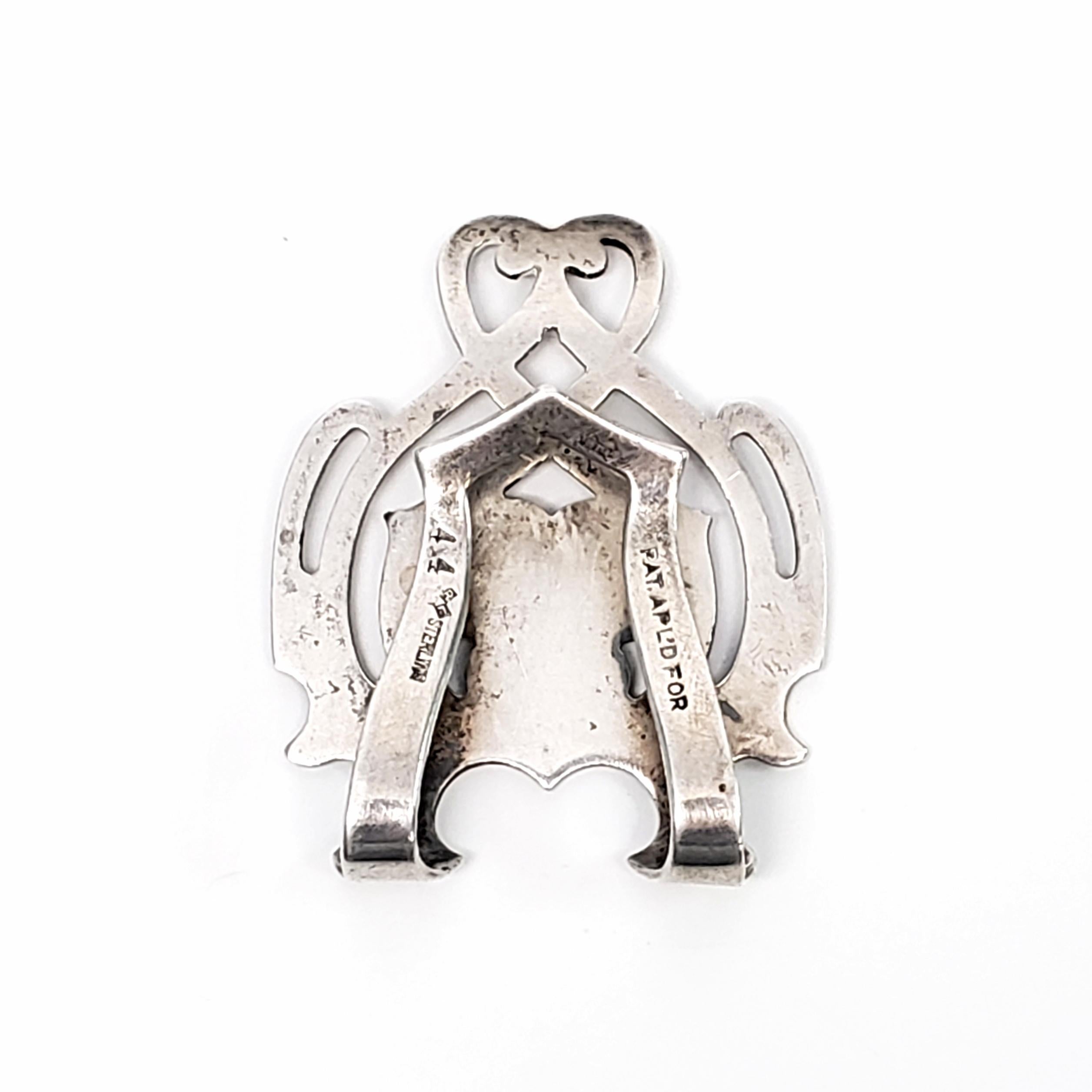 Vintage sterling silver napkin clip by Rogers, Lunt & Bowlen Co, #44.

Engraved with the name Susie.

Cut-out scroll design by Rogers, Lunt & Bowlen, incorporated in 1902 in Greenfield, MA. The RLB hallmark dates the piece to