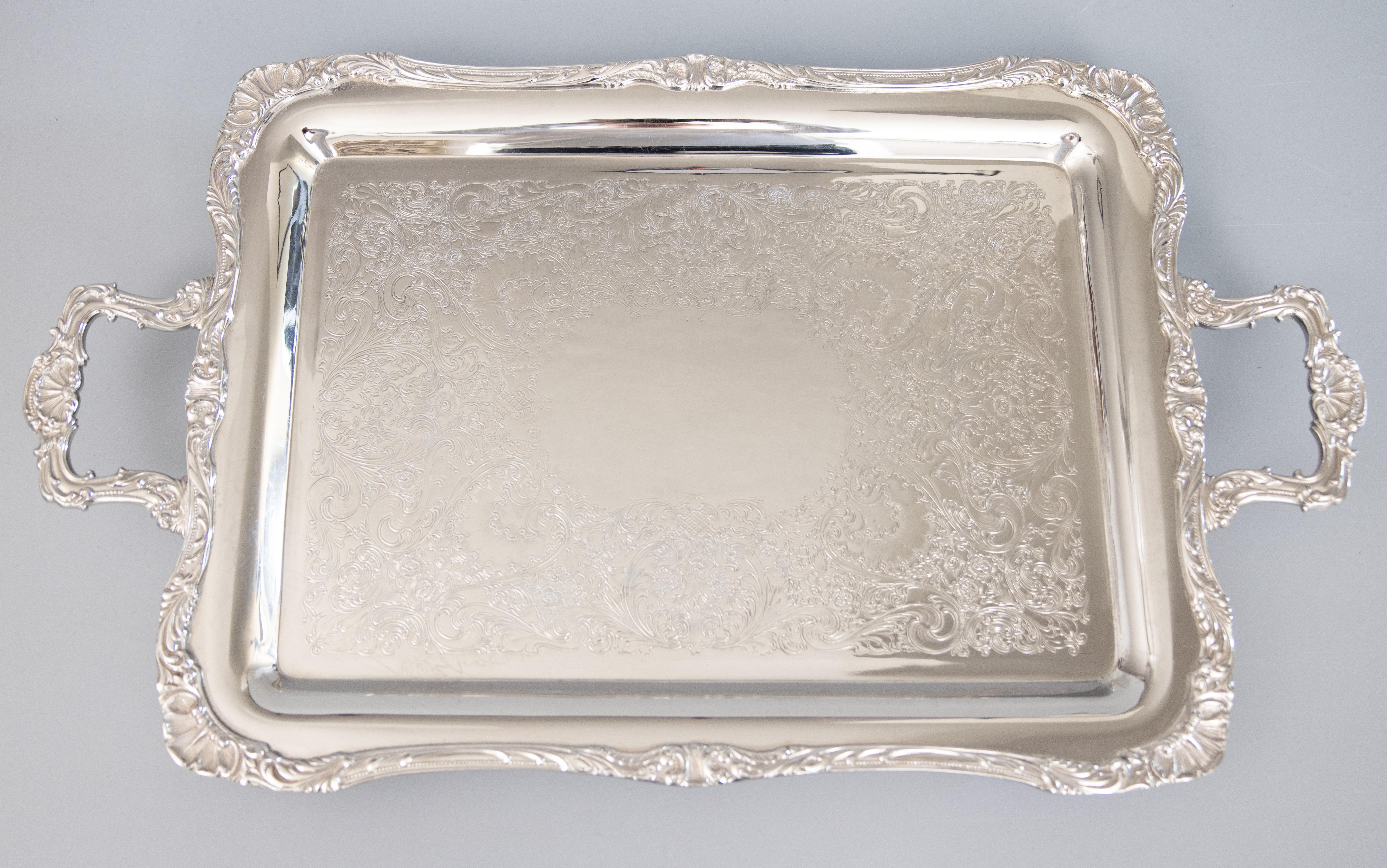 A superb early to mid-20th century silverplated rectangular footed serving tray by Rogers & Bro. Maker's mark on reverse. This fine quality silver tray is heavy and well made with gorgeous details on the edges, handles, and feet. It would be