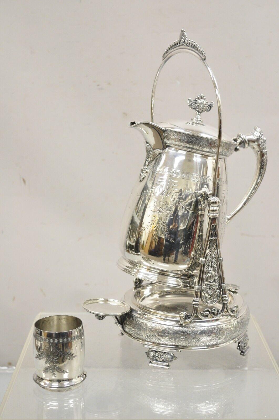 Rogers Smith & Co Silver Plated Victorian Tilting Lemonade Water Pitcher w Stand. Item features Floral repousse with birds and vines, single goblet cup, tilt mechanism for easy pouring, original hallmark, very nice antique item. Circa 1900s.