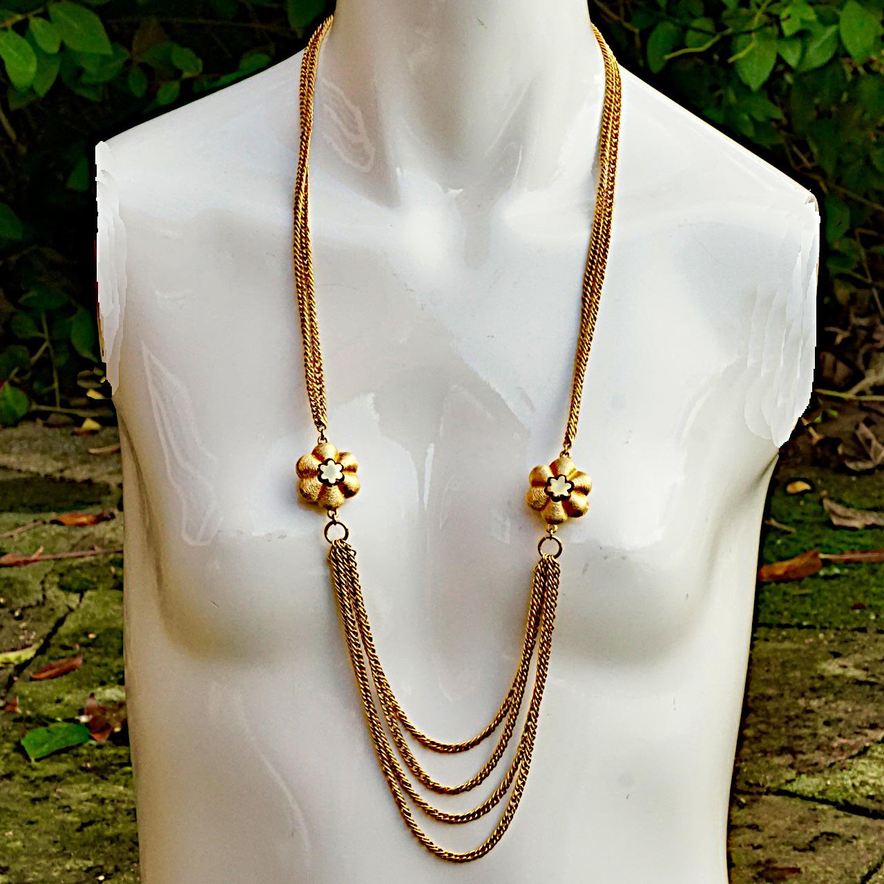 Roget gold plated necklace with four strands of chains, and featuring two brushed and shiny flowers. The shortest length is approximately 76 cm / 30 inches, and the flowers are diameter 2.4 cm / .94 inch. The necklace is in very good