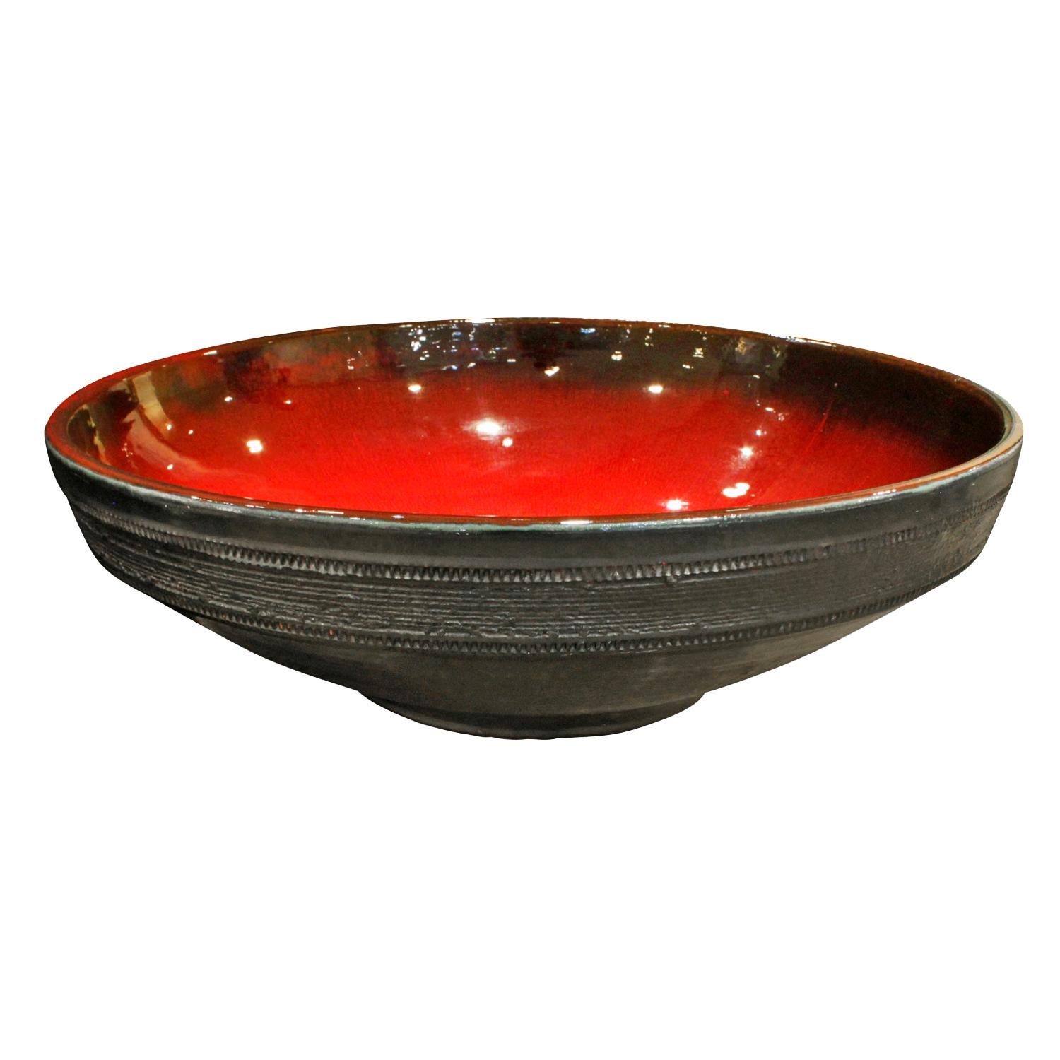 Monumental hand thrown ceramic bowl with dynamic red glaze inside and a rough black glaze outside by Rogier Vandweghe for Amphora Ceramics, Belgium 1960s (imprinted 