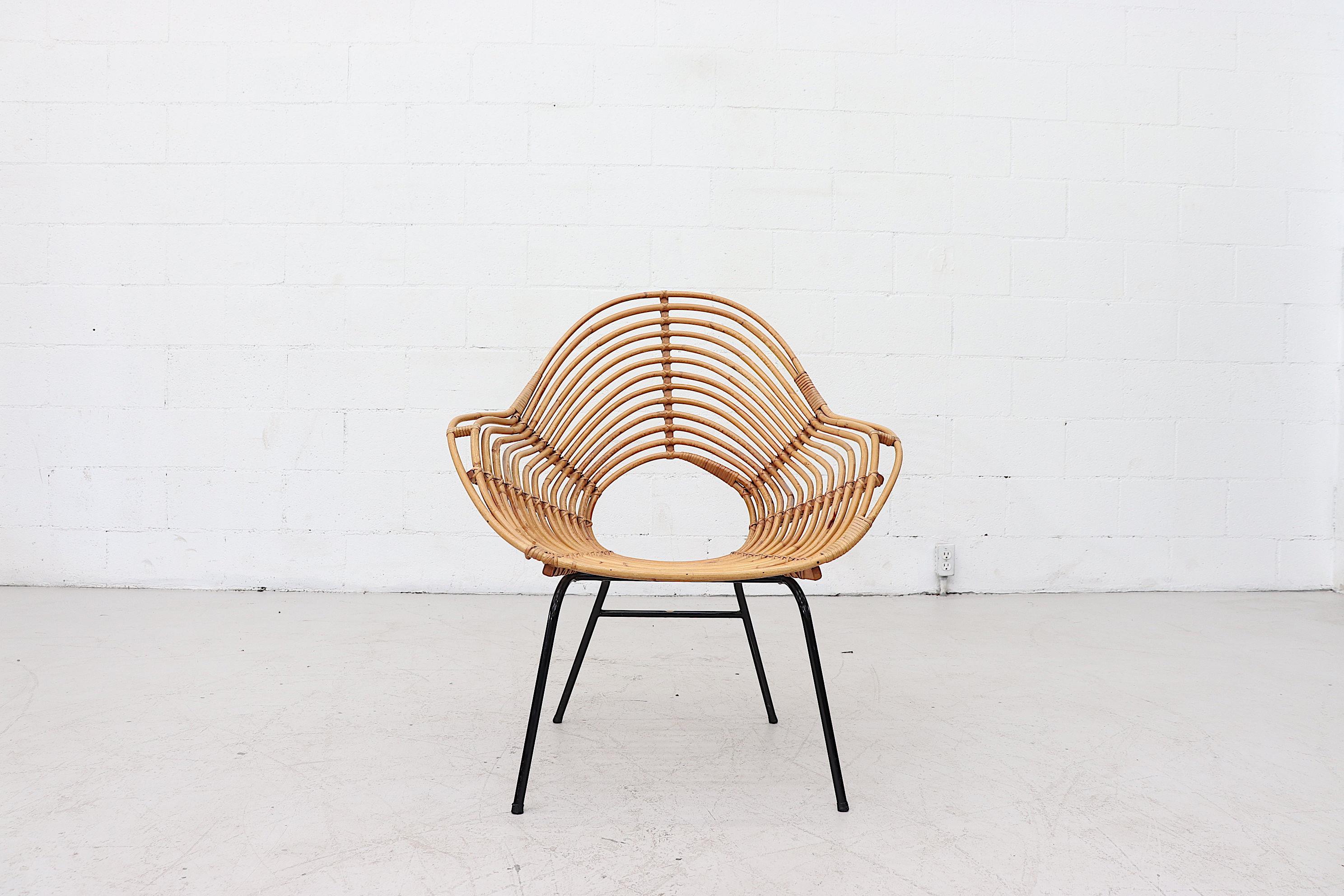 Beautiful onion skin patterned bamboo lounge chair with black enameled tubular frame. Retains original label. In original condition with visible patina and minimal enamel loss.