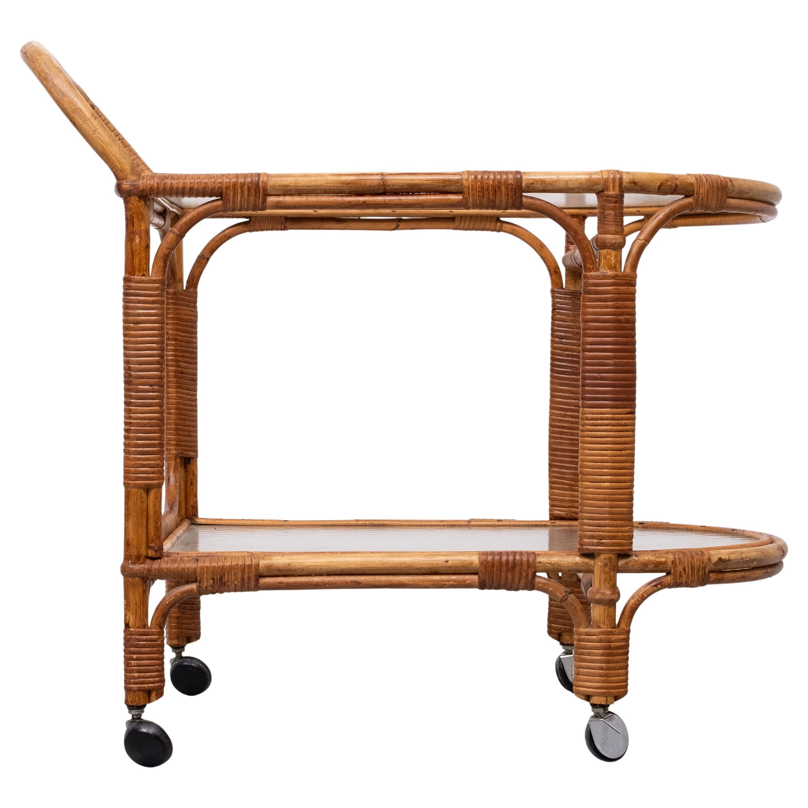 Very Nice Rattan serving trolley . on Chrome wheels ,comes 
with original waved Glass tops . Very good condition . 
Easy and light in weight .  