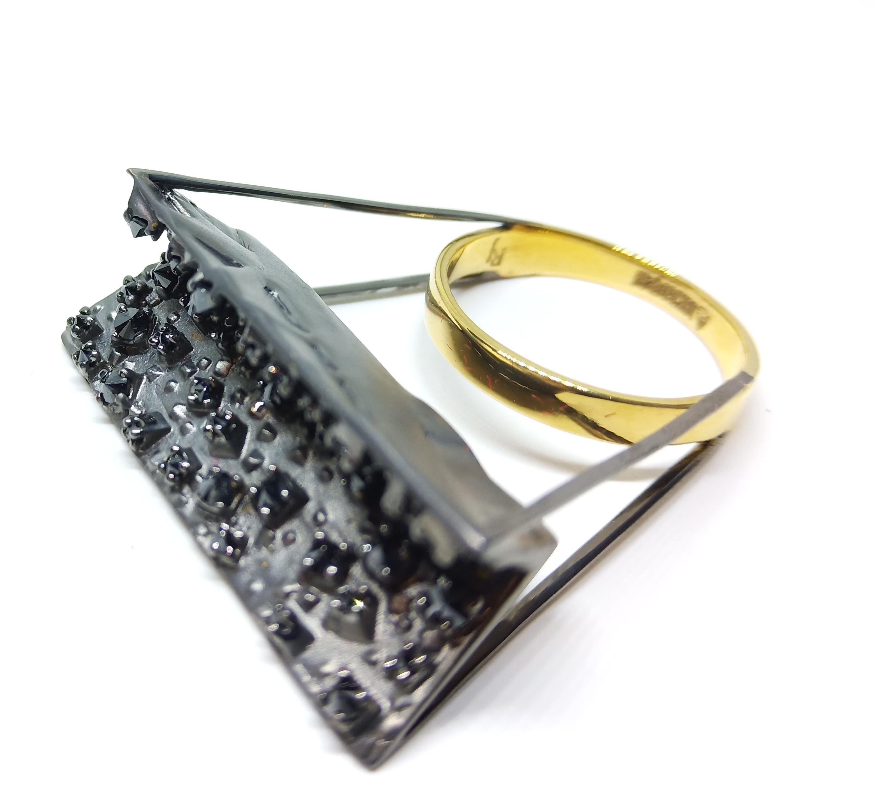 A Out of the Box designed, One Of A Kind Cocktail Ring featuring Yellow and Raw Dull Black Gold finish, predominantly. Inverted Round Black Diamonds are set on top of cubicles of varying shapes and placed at different angles on top of Ring. The top