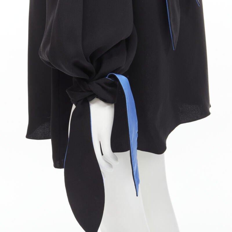 ROKSANDA 100% silk black blue bow tie cuff tunic dress  UK8 S
Reference: JACG/A00020
Brand: Roksanda
Material: Silk
Color: Black, Blue
Pattern: Solid
Closure: Self Tie
Extra Details: Keyhole back. Self tie at back of neck and at cuff.
Made in:
