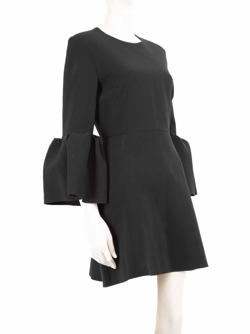 CONDITION is Very good. Hardly any visible wear to the dress is evident on this used Roksanda designer resale item.
 
 
 
 Details
 
 
 Black
 
 Polyester
 
 Dress
 
 Mini
 
 Long ruffle trim sleeves
 
 Round neck
 
 Back zip and hook fastening
 
 
