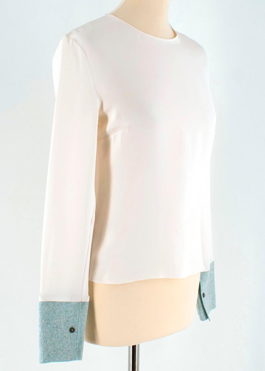 Roksanda Faille-Paneled Silk-Cotton Top 

Top
Silk/cotton 
Contrasting cuffs in blue 
Button closure on cuff
Long sleeves
Hook and eye closure 
concealed zip fastening at back
White hardware
Light weight 

Please note, these items are pre-owned and