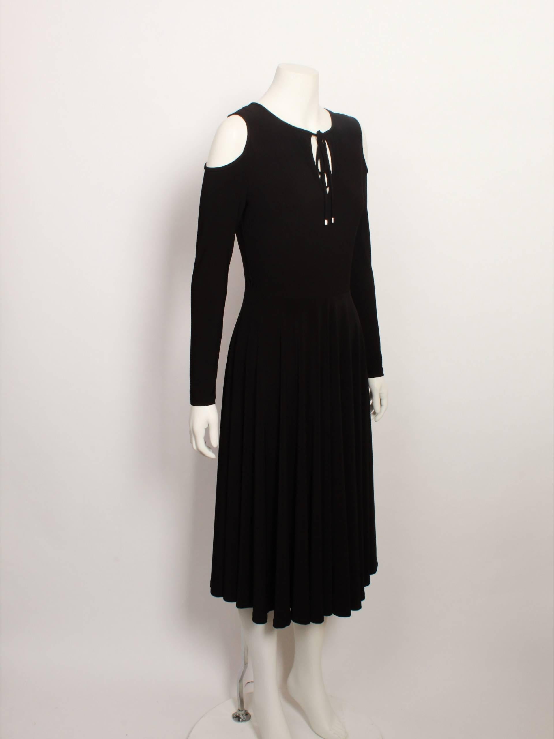 Roksanda is a Serbian designer based in London & a graduate of Central Saint Martins well known for her simplicity and elegant designs. 

This black stretch dress offers a decidedly modest approach to peek-a-boo detailing with a small keyhole cut
