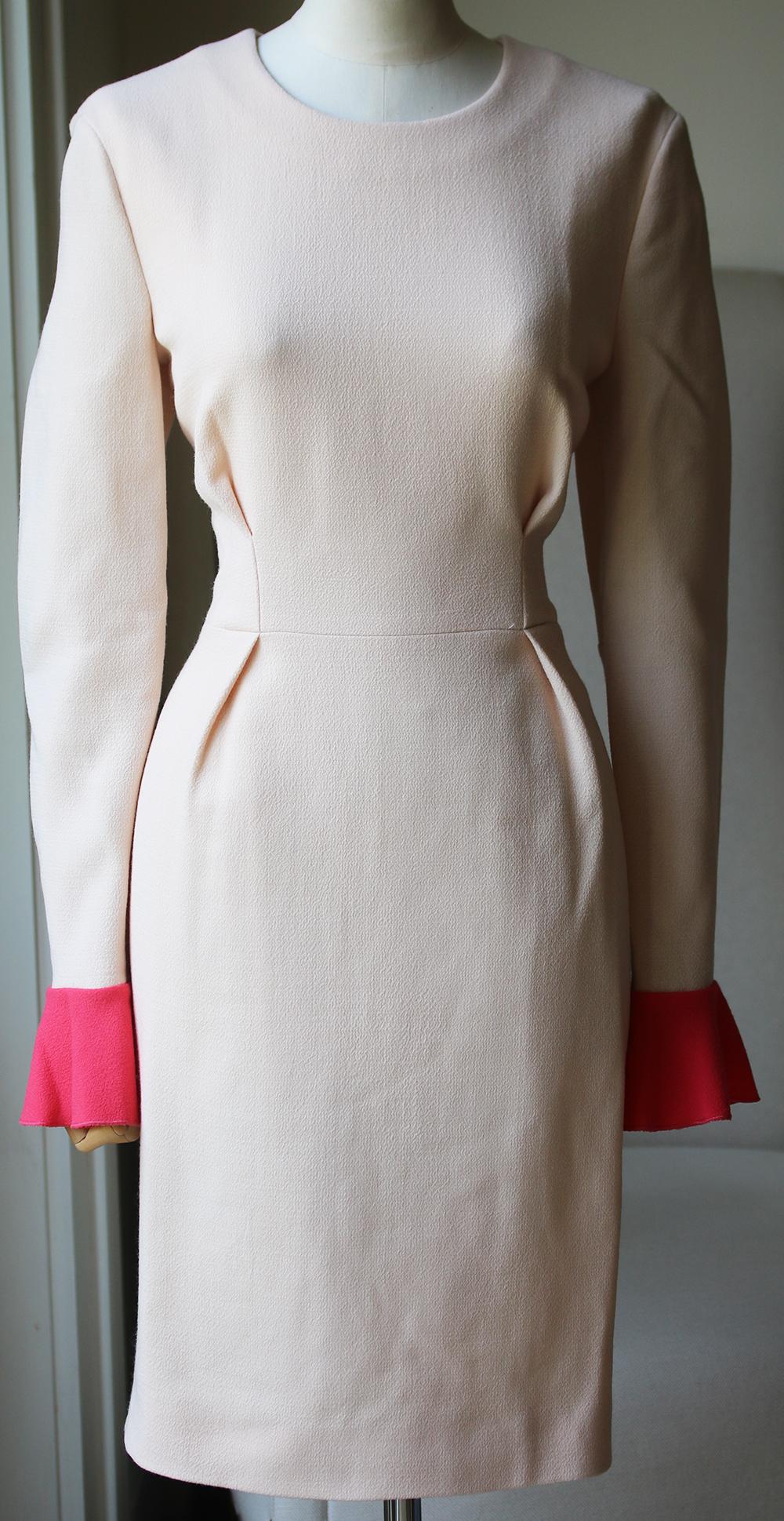 Roksanda Ilincic's beautiful dresses are hot property on the party circuit, and we love this blush wool-crepe design with contrasting royal-blueruffled cuffs. Cut for a super sleek silhouette, this ladylike piece is destined for the chicest events
