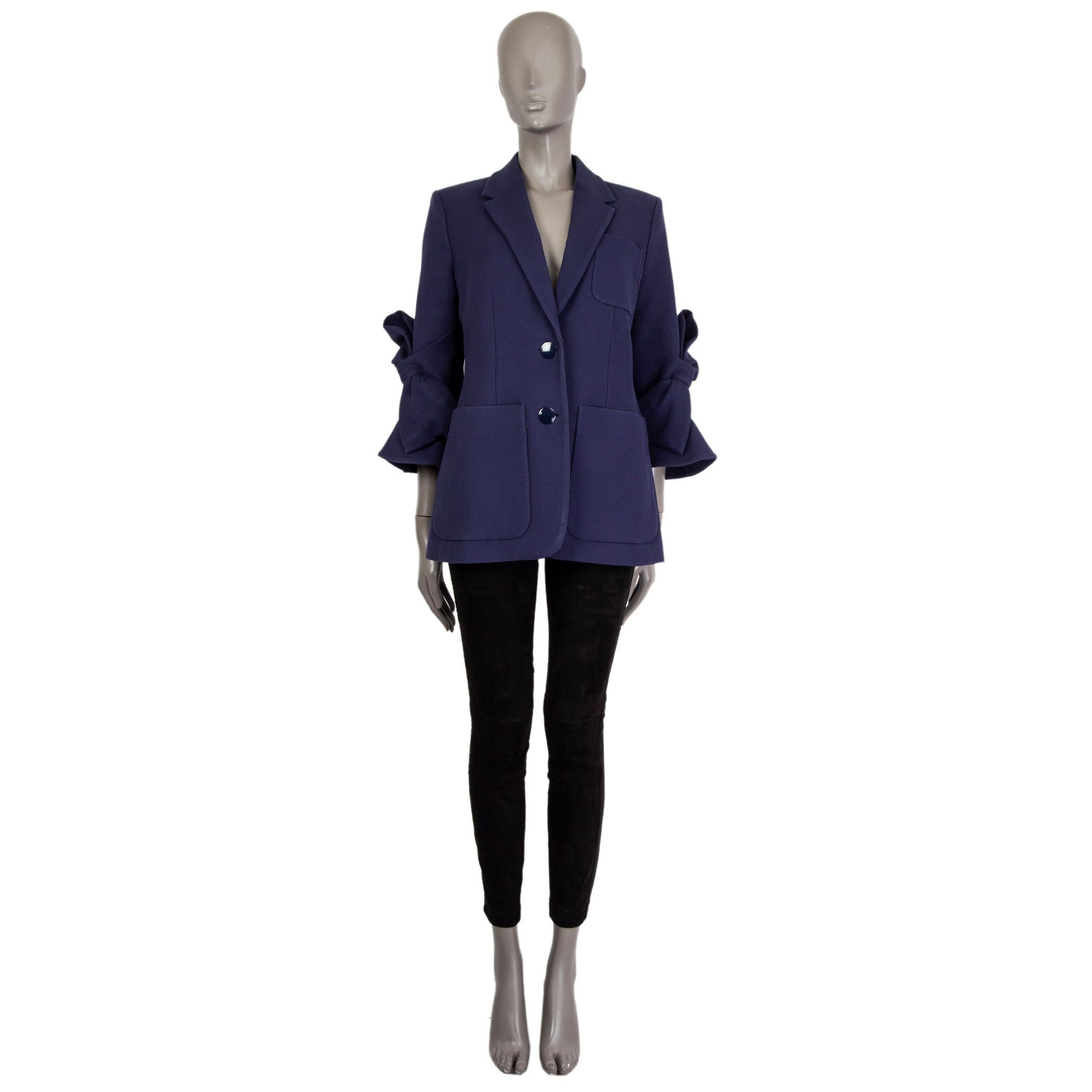 100% authentic Roksanda bow-sleeve blazer in indigo cotton (100'%). With notch collar and three patch pockets on the front. Closes with two flat buttons in indigo enamel on the front. Lined in salmon, pink, olive, and indigo silk (100%). Hss been