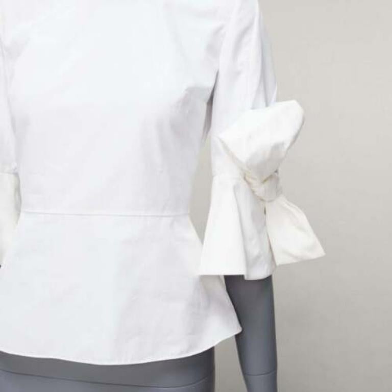 ROKSANDA Kemi white cotton poplin bow cuff flared sleeve peplum top UK6 XS
Reference: AAWC/A00665
Brand: Roksanda
Model: Kemi
Material: Cotton
Color: White
Pattern: Solid
Closure: Zip
Extra Details: Roksanda's iconic Kemi style is updated in