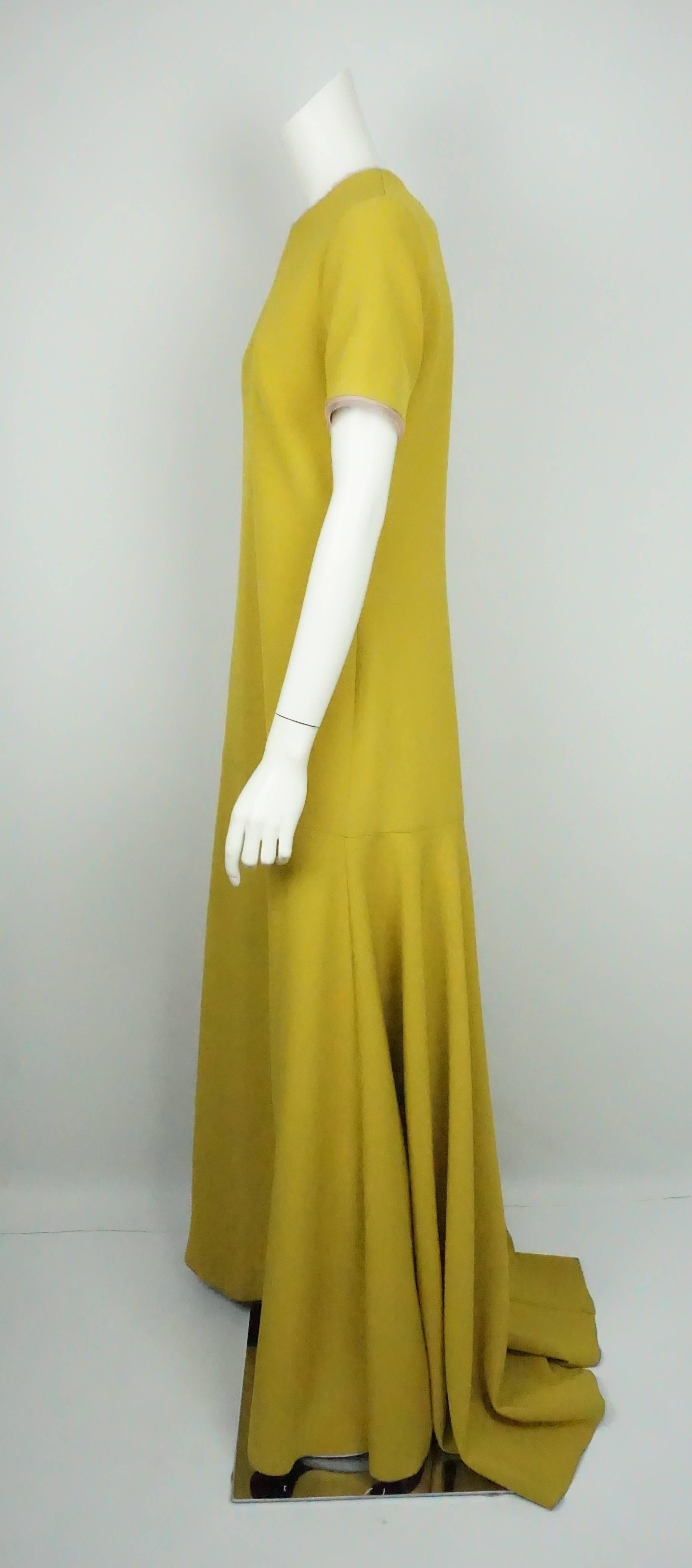 Roksanda Mustard S/S Gown w/ Silver Back Zip - 10  This simple yet elegant piece is in excellent condition. The dress is made of polyester and is lined in silk. The top of the dress has a round neckline and has short sleeves. Around the sleeves and