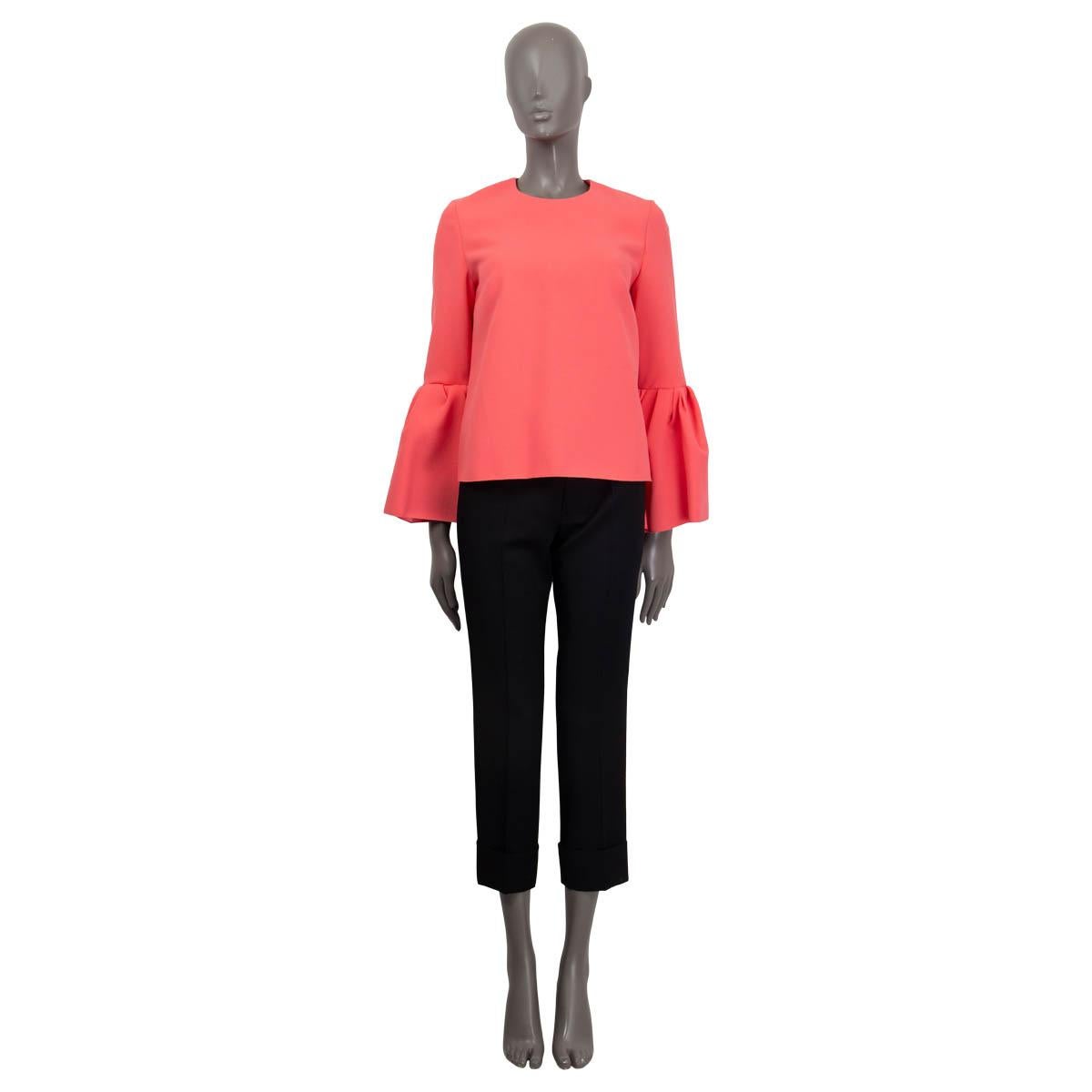 100% authentic Roksanda Truffaut bell-sleeve shirt in coral pink polyester (97%) and elastane (3%). Features a round neck and long sleeves. Opens with a concealed zipper and a hook on the back. Unlined. Has been worn and is in excellent
