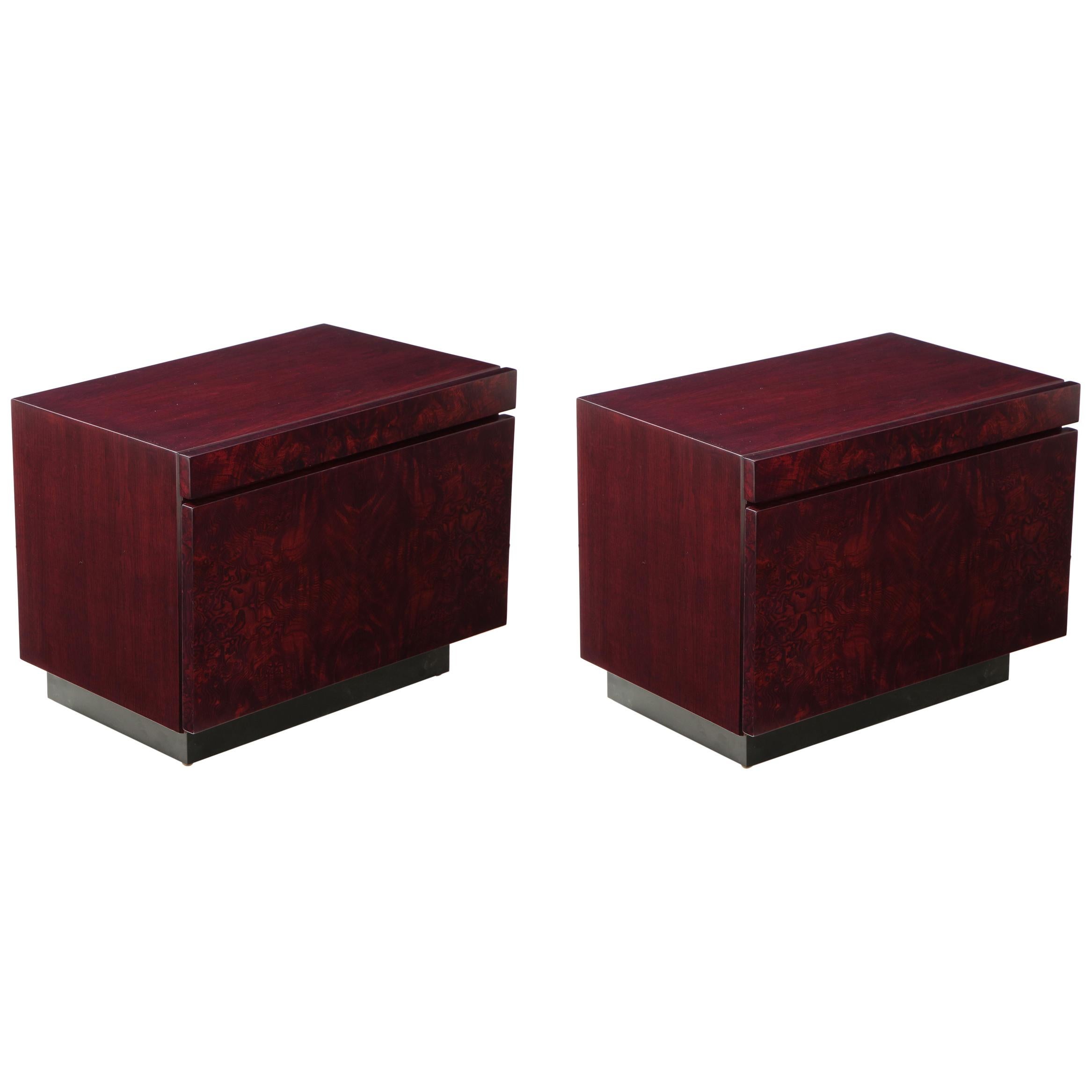 Pair of mint restored burl nightstands featuring a custom color red wine stain. Each featuring an ample sized bottom drawer and a laminate lined pullout / pull-out drinks tray all sitting on a matte black lacquer base. Roland Carter for Lane.