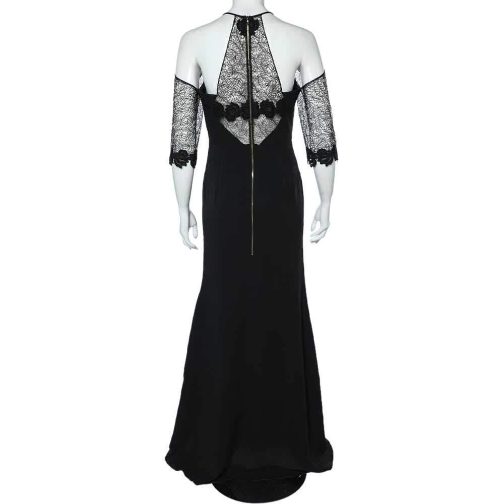 Charmingly tailored into a chic, floor-length silhouette, this Carrington gown from the House of Roland Mouret brings endless beauty, poise, and demure to your style. It is fashioned in black crepe fabric, highlighted with intricate lace panels. It