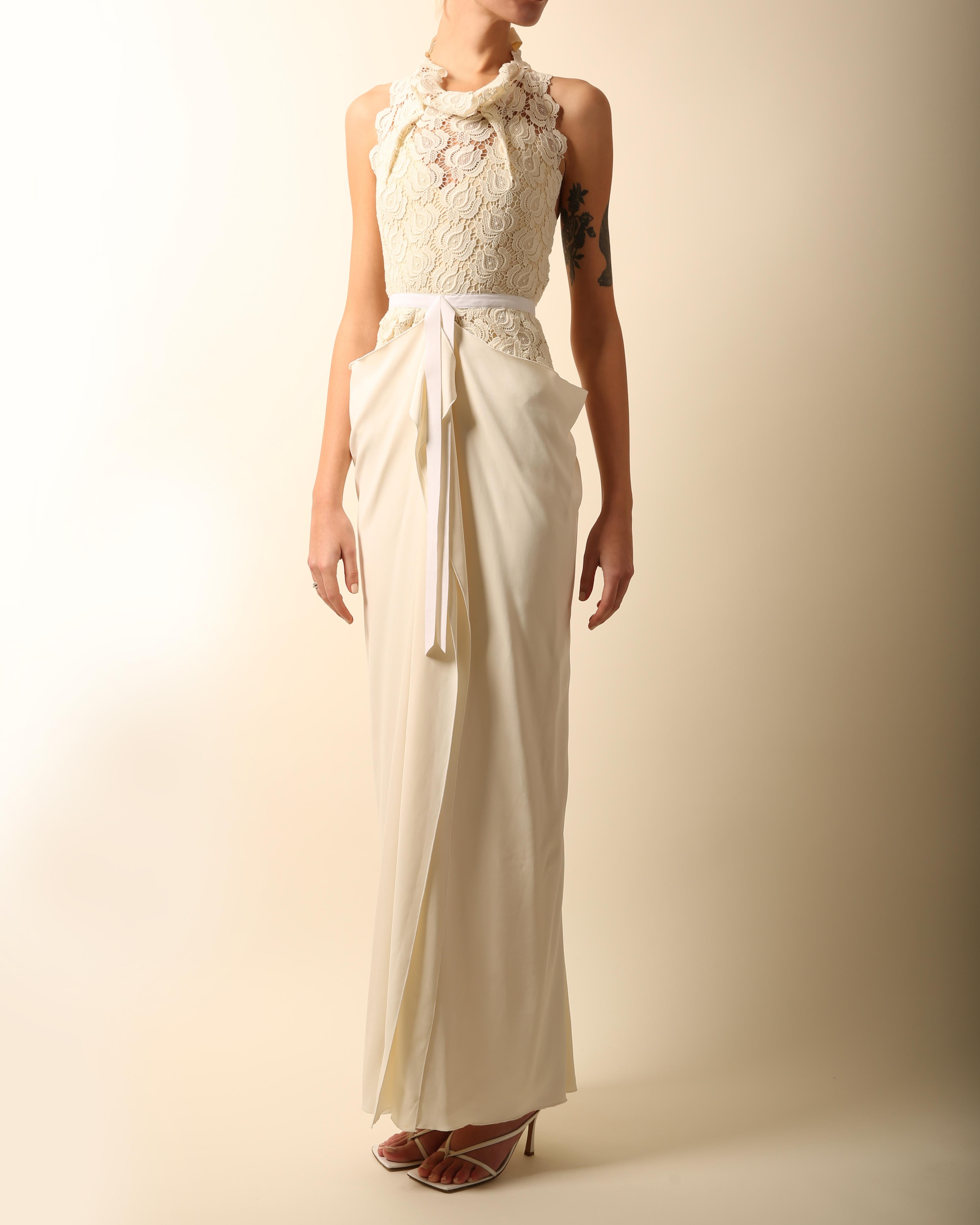 Roland Mouret
Ivory & cream full length dress with a beautiful lace upper
Draping neckline
Cinched in waist tied with a white velvet ribbon
Ties at the back of the neck and waist with long silk cream ties
Cut out back
Silk lining
Exposed back zip