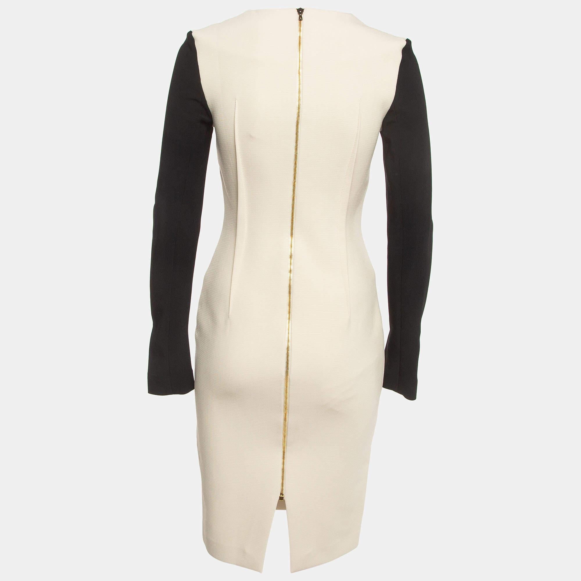 The Roland Mouret Kutim dress combines timeless elegance with contemporary flair. Crafted from a luxurious wool blend, this dress features a monochrome color block design that effortlessly flatters the silhouette. With its long sleeves and a