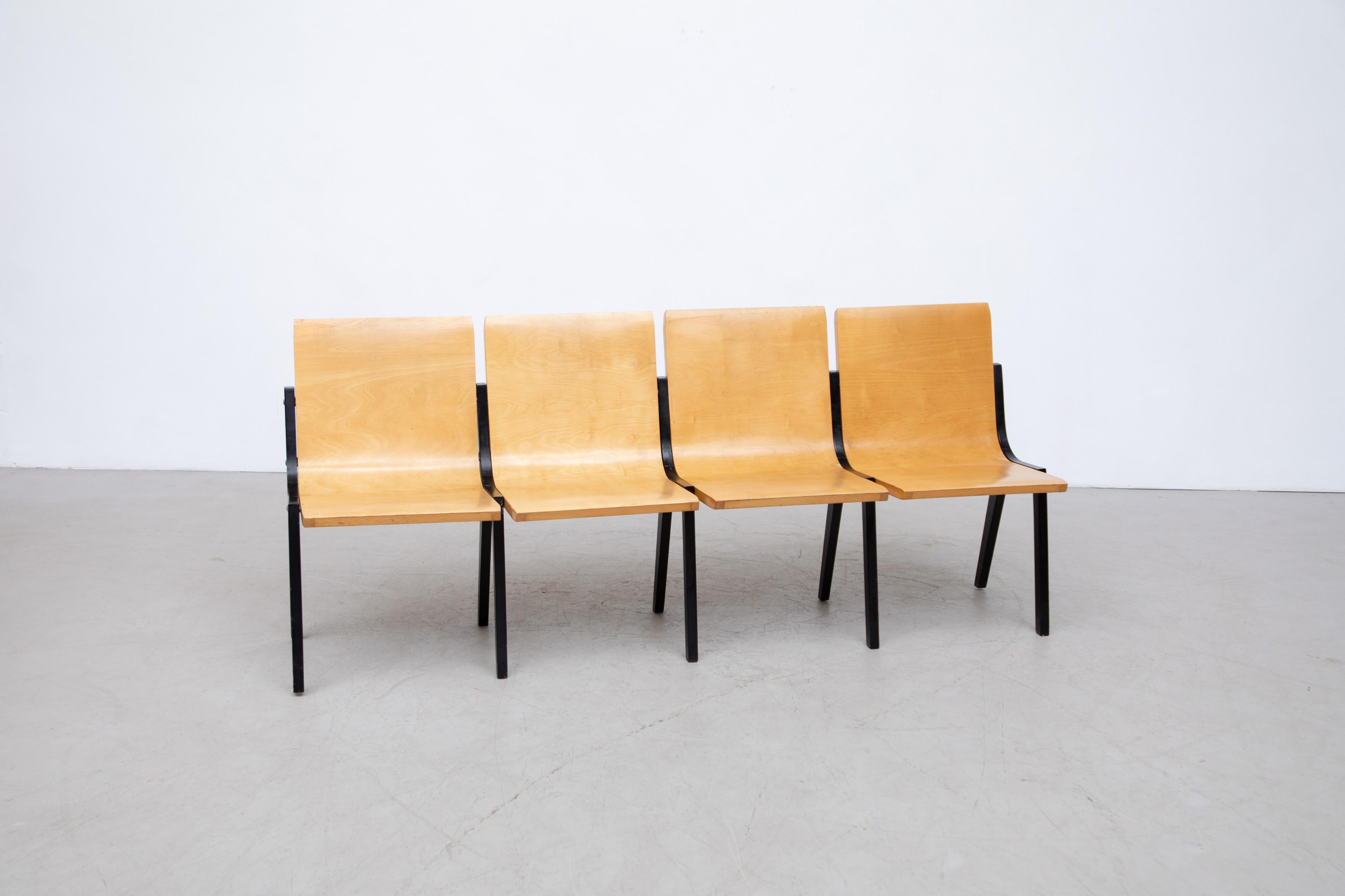 Roland Rainer 4 seat bench with bent beech plywood seating and black wood legs from a Dutch Church. In original condition with visible patina and signs of wear consistent with its age and use. Other sizes available in 2, 3 and 5 seaters