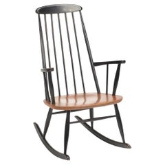 Chaise longue à bascule en teck Roland Rainer