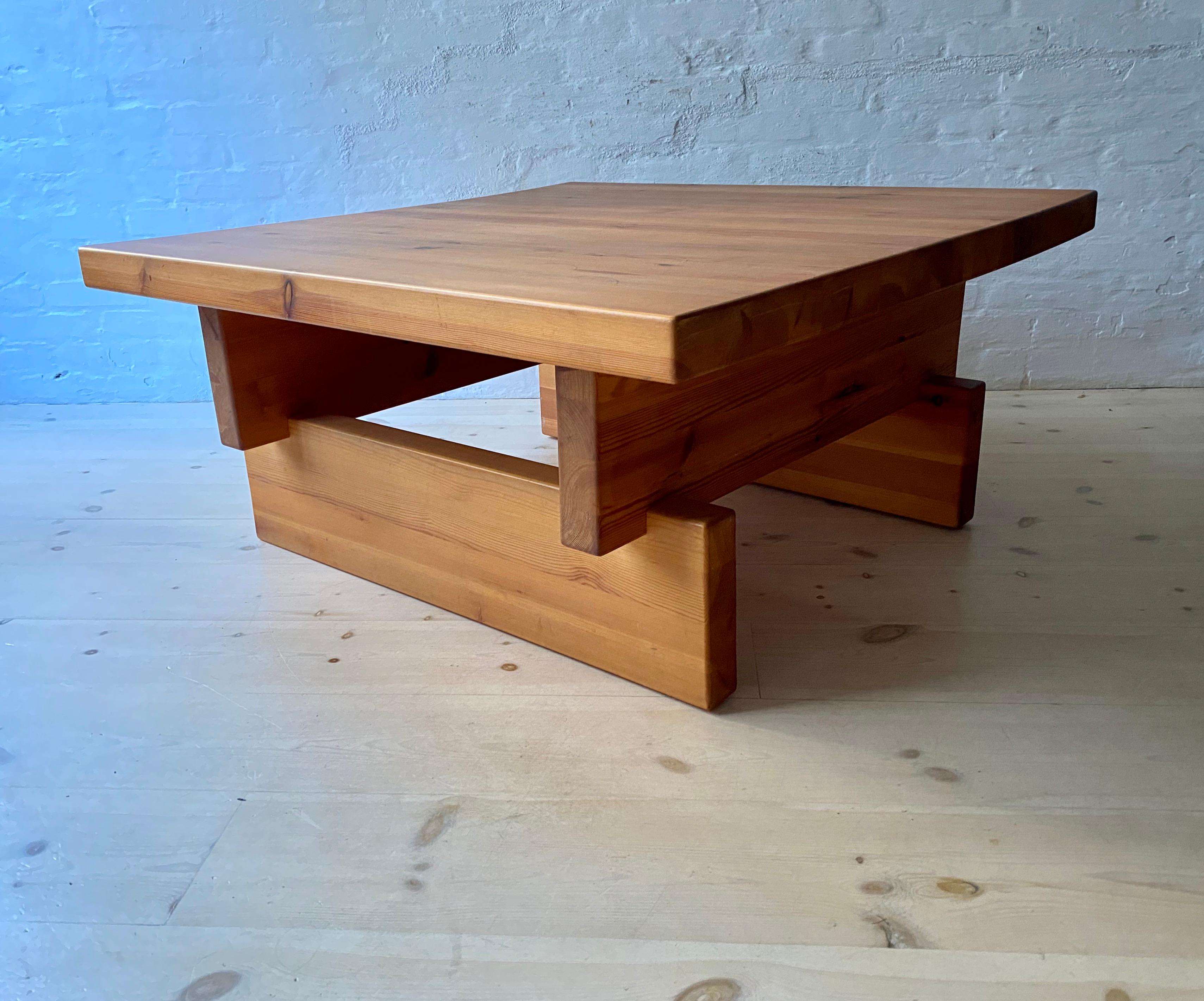 A large coffee table in Swedish pine designed by Roland Wilhelmsson and produced by Karl Andersson and Soner AB, Sweden. With a square top set on opposed supports. The thickness of the top and supports is 5.5cm. (2 1/4in.) The character of this type
