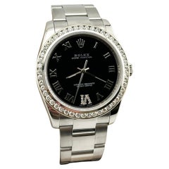 Rolex 114200 34mm Black Roman Dial Diamond Bezel Stainless Steel
