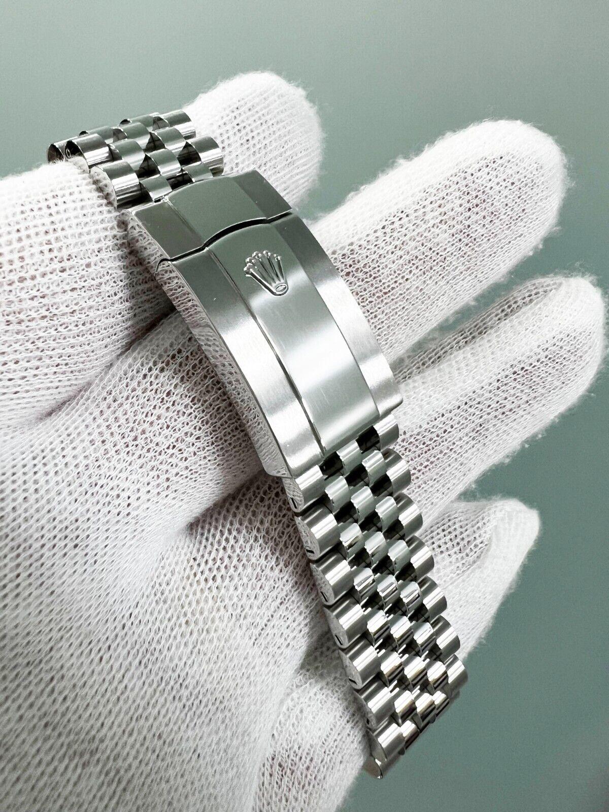 Style Number: 126234
Serial: 79C16***
Year: 2020
Model: Rolex Datejust
Case Material: Stainless Steel 
Band: Stainless Steel 
Bezel: 18K White Gold Fluted
Dial: Silver - Factory Roman Numeral with Diamonds on the 6 and 9 o clock
Face: Sapphire
