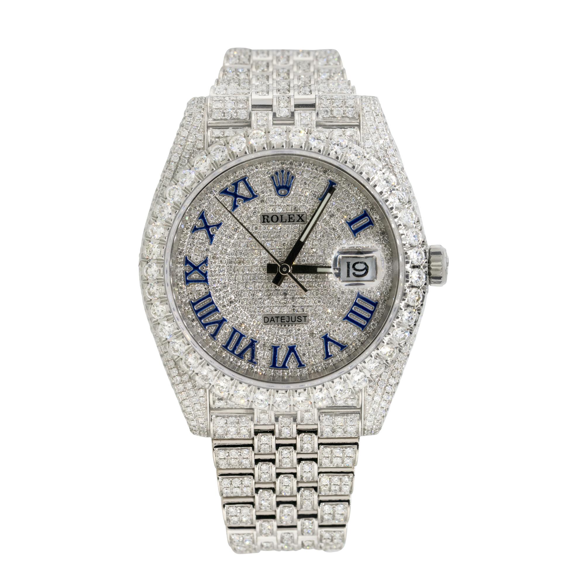 Brand: Rolex
MPN: 126300
Model: Datejust II
Case Material: Stainless steel with aftermarket Diamonds
Case Diameter: 41mm
Crystal: Sapphire Crystal
Bezel: Stainless steel bezel with aftermarket Diamonds
Dial: Dial with blue roman numerals covered in