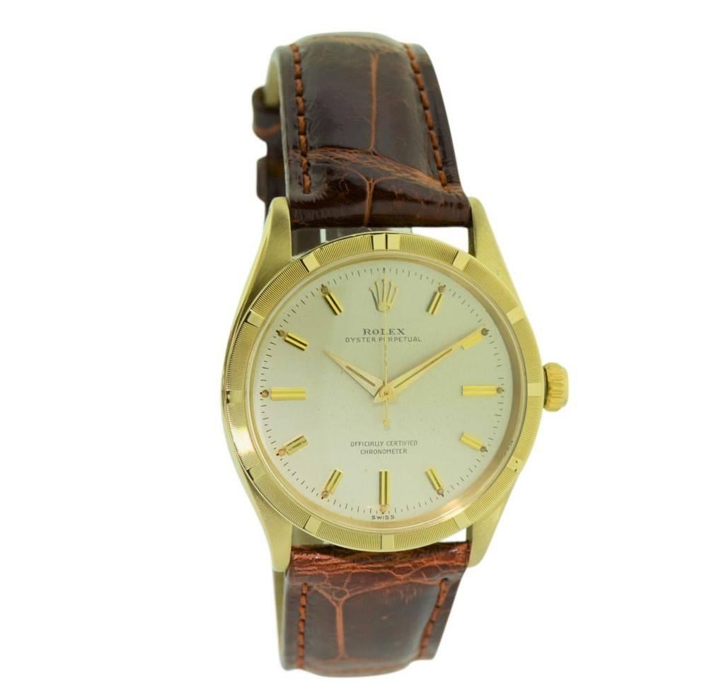 FACTORY / HOUSE: Rolex Watch Company
STYLE / REFERENCE: Oyster Perpetual / Ref. 6569
METAL / MATERIAL: 14 Kt. Solid Gold
CIRCA: 1957-1958
DIMENSIONS: 41mm X 34mm
MOVEMENT / CALIBER: Perpetual Winding / Jewels 
DIAL / HANDS: Original Silvered Applied
