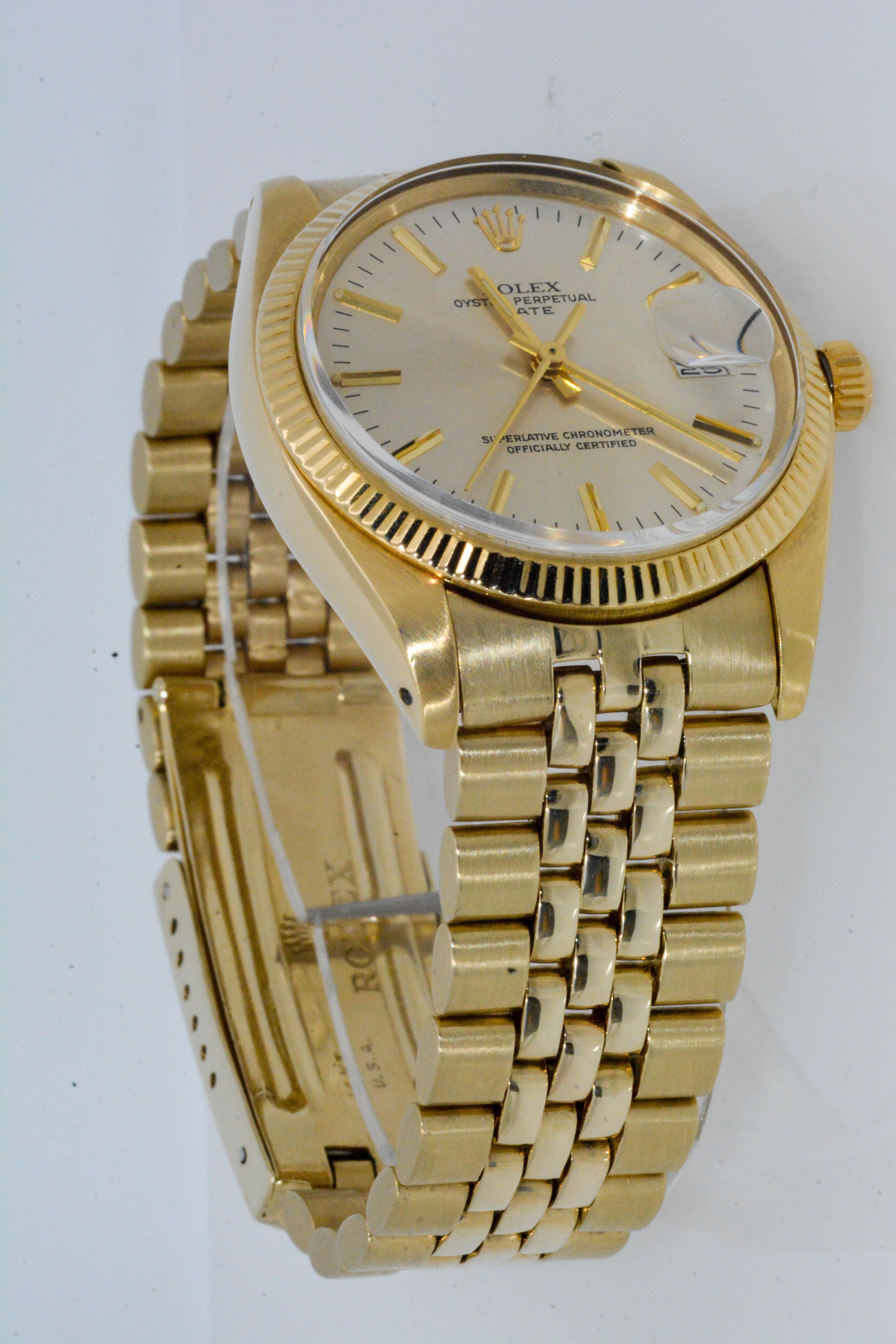 Circa 1978, Certified Pre-Owned 14 karat yellow gold ROLEX Date Silver Streak dual Jubilee bracelet watch. 