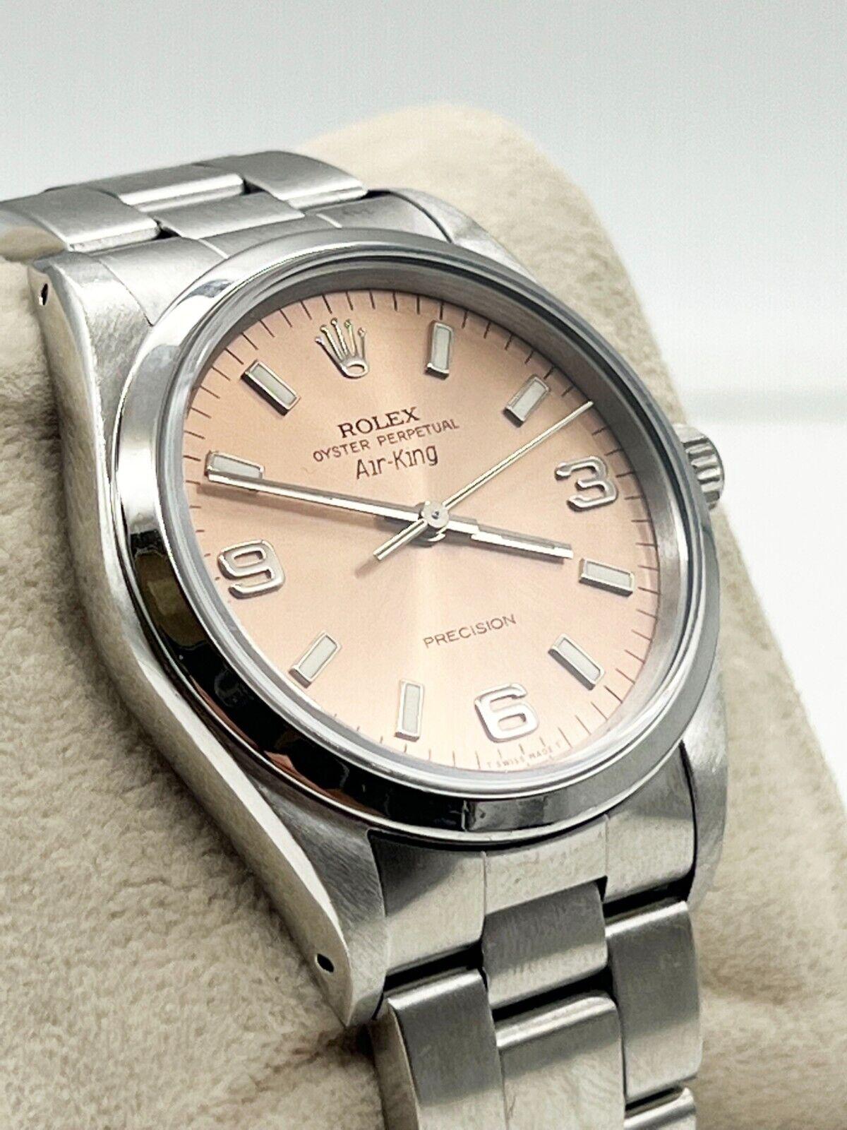 Style Number: 14000

Serial: N432***

Year: 1991

Model: Air King

Case Material: Stainless Steel 

Band: Stainless Steel 

Bezel: Stainless Steel Smooth Bezel 

Dial: Pink / Salmon 

Face: Sapphire Crystal 

Case Size: 34mm 

Includes: 

-Elegant