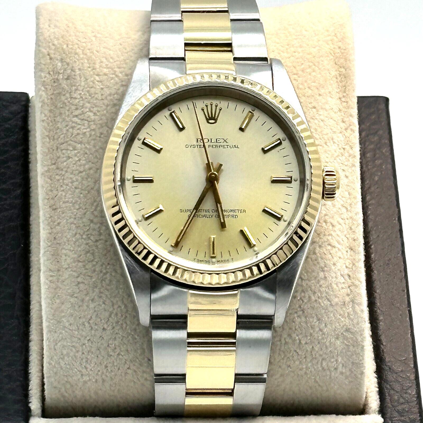 Style Number: 14233

Serial: P237***

Year: 2000

Model: Oyster Perpetual

Case Material: Stainless Steel

Band: 18K Yellow Gold & Stainless Steel

Bezel: 18K Yellow Gold

Dial: Faded Champagne Dial

Face: Sapphire Crystal

Case Size: