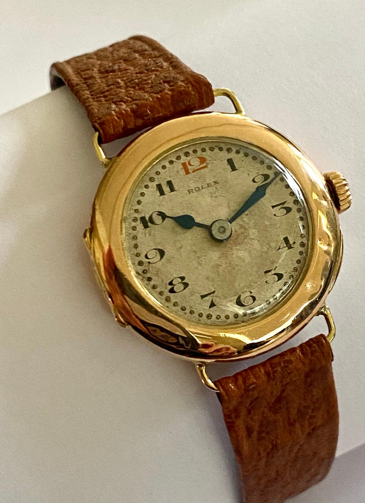 One (1) 14K. rose gold ladies' wristwatch with a leather strap, hand wound with a 15 stone anchor movement signed; ROLEX
Case Diameter 26 mm, thickness 8 mm. case no: L001997  signed ROLEX
The watch is in good condition and keeps time well and is in