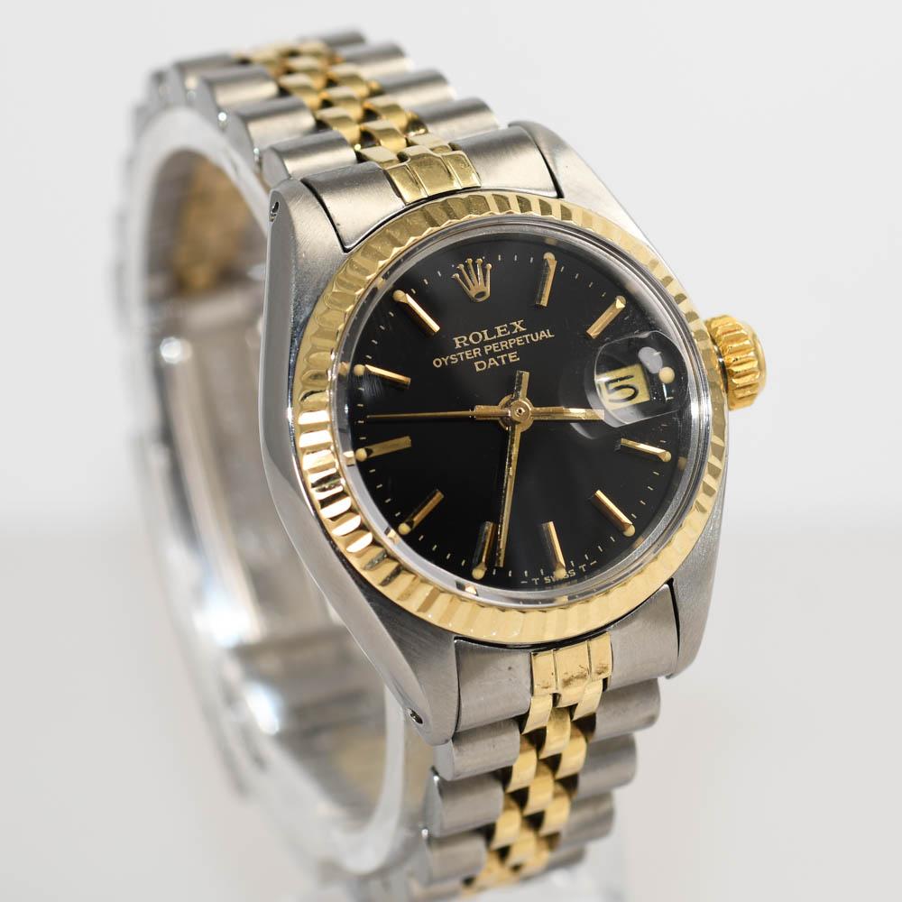 Ladies Rolex date wristwatch, 14k yellow gold and stainless steel.
26mm case size.
Black dial. Model number 6917, serial number 5948636.
Made in 1978.
Automatic movement runs fine.
Crystal and dial look excellent.
Very little stretch on the jubilee