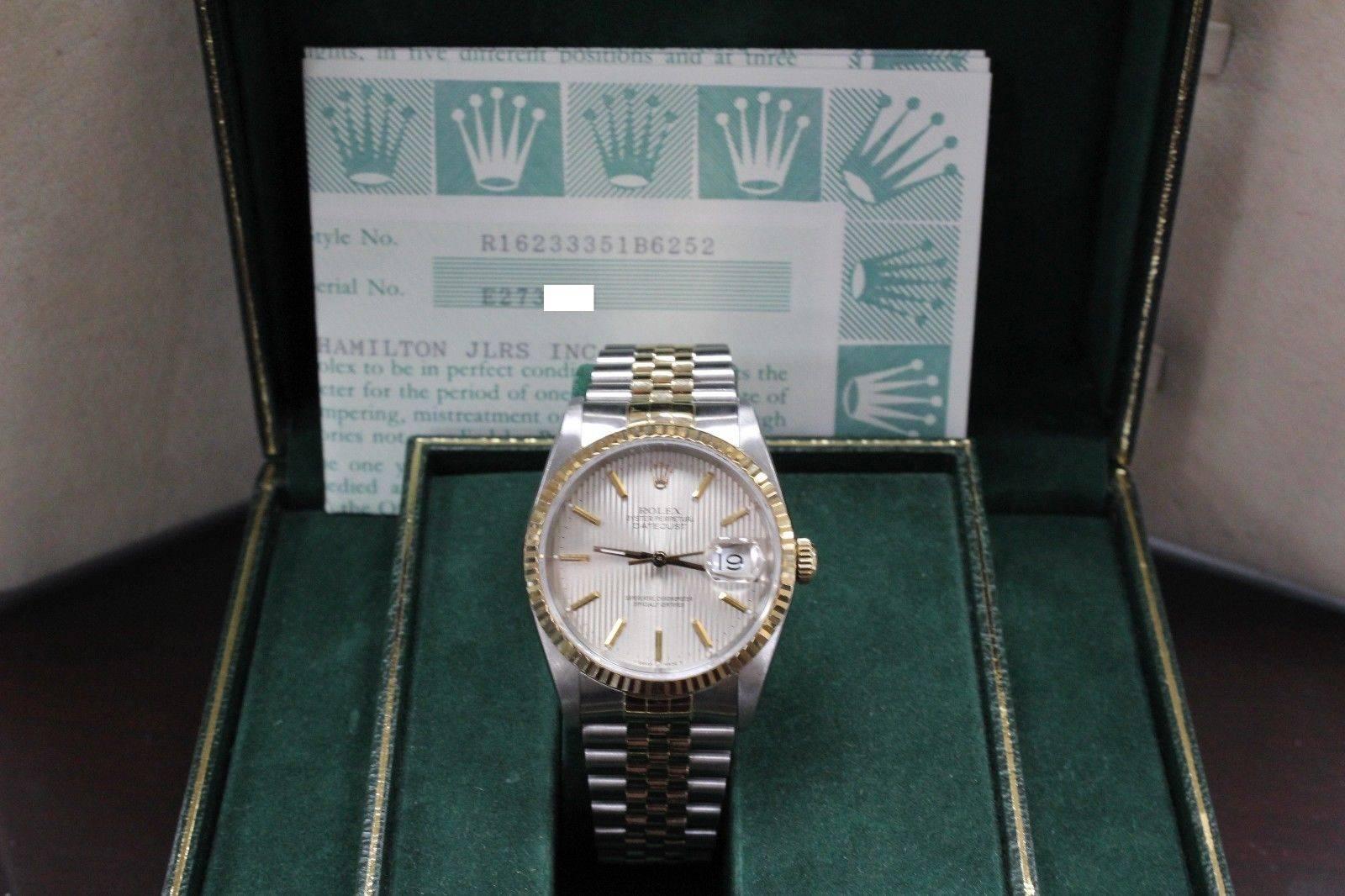 Style Number: 16233
Serial: E273***
Model: Datejust
Case: Stainless Steel
Band: 18K Yellow Gold & Stainless Steel 
Bezel: 18K Yellow Gold
Dial: Silver
Face: Sapphire Crystal 
Case Size: 36mm
Includes: 
-Rolex Box & Papers
-Certified Appraisal 
-6