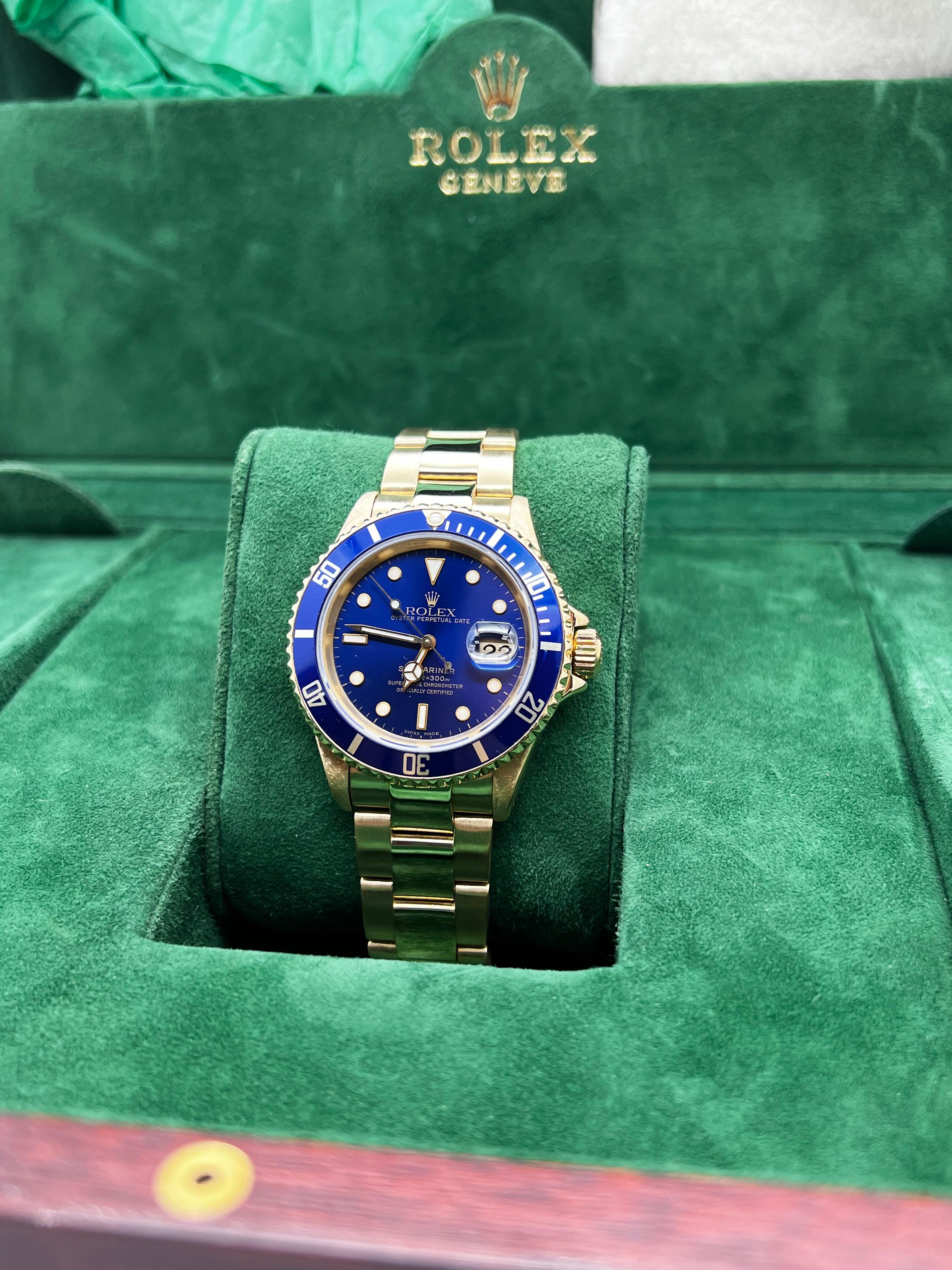 Style Number: 16618
Serial: N269***
Year: 1991
Model: Rolex Submariner
Case Material: 18K Yellow Gold 
Band: 18K Yellow Gold 
Bezel: Blue
Dial: Blue 
Face: Sapphire Crystal 
Case Size: 40mm 
Includes: 
-Rolex Watch Box
-Certified Appraisal 
-1 Year