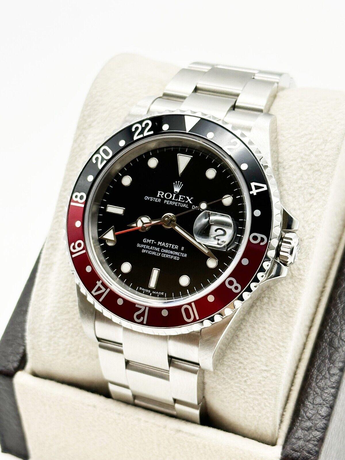 Style Number: 16710

Serial: D695***

Year: 2005 

Model: GMT Master II  

Case Material: Stainless Steel  

Band: Stainless Steel  

Bezel: Coke - Red and Black  

Dial: Black 

Face: Sapphire Crystal 

Case Size: 40mm 

Includes: 

-Elegant Watch