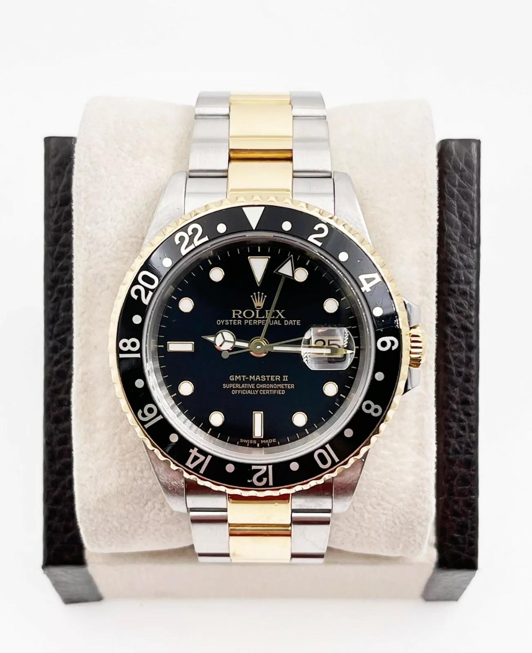 Style Number: 16713
Serial: P489***
Year: 2001
Model: Rolex GMT Master II 
Case Material: Stainless Steel 
Band: 18K Yellow Gold & Stainless Steel 
Bezel: Black
Dial: Black
Face: Sapphire Crystal 
Case Size: 40mm
Includes: 
-Rolex Box and
