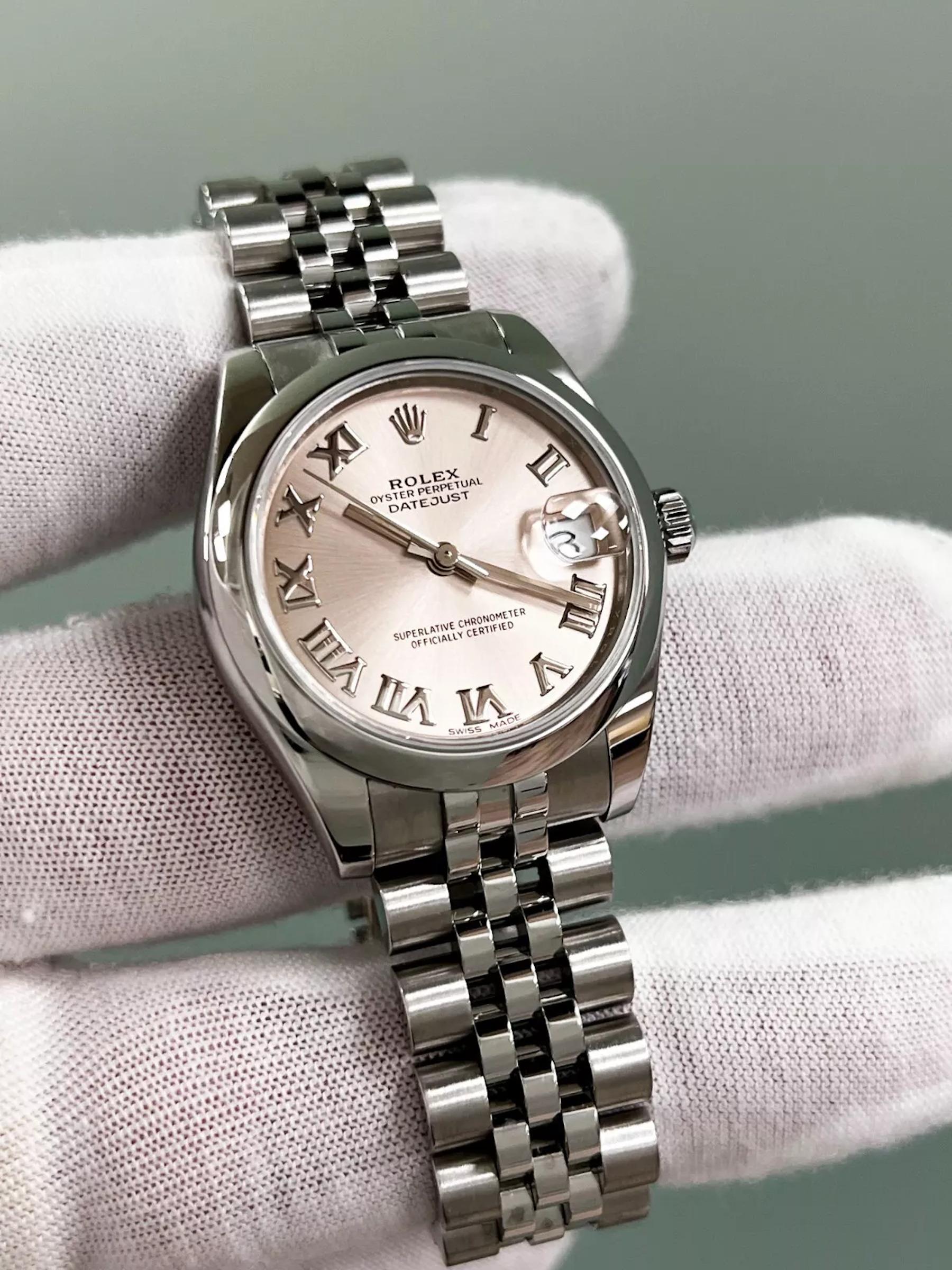 Style Number: 178240

Serial: 71P26***

Year: 2020

Model: Datejust 

Case Material: Stainless Steel 

Band: Stainless Steel 

Bezel: Stainless Steel 

Dial: Pink Roman Dial 

Face: Sapphire Crystal 

Case Size: 31mm 

Includes: 

-Rolex Box &
