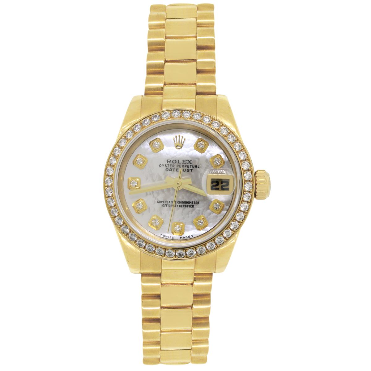 Brand: Rolex
MPN: 179138
Model: Presidential
Case Material: 18k yellow gold
Case Diameter: 26mm
Bezel: Factory 18k yellow gold diamond bezel
Dial: Factory dial with diamond hour markers, yellow gold hands and date window at the 3 o’clock