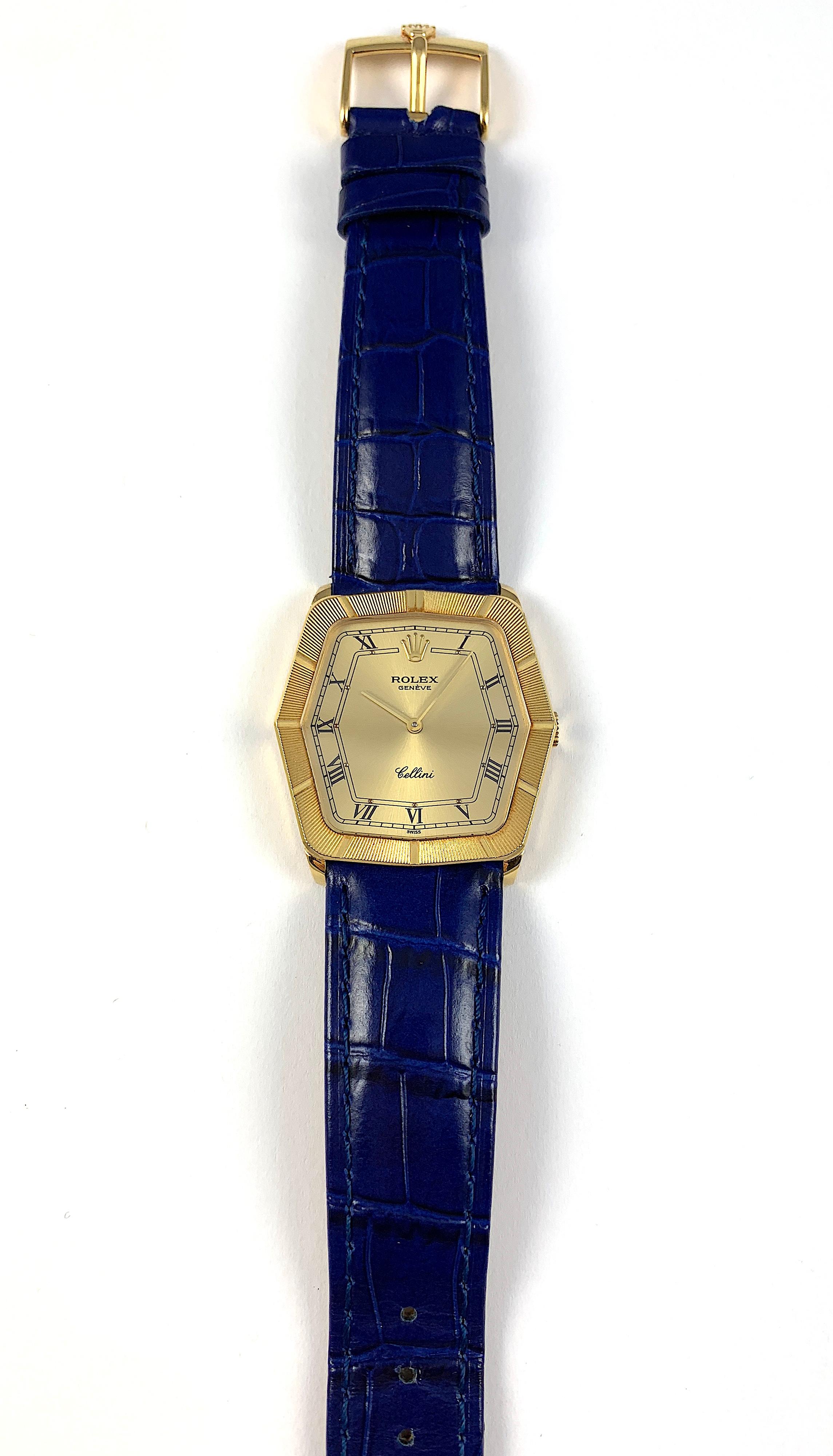 Rolex Cellini 18K Yellow Gold Manual Wind Wristwatch
Factory Champagne Decorated Dial with Applied Rolex Crown and Roman Numerals and Gold Dots Above the Roman Numeral Markers
Decorated Etched Bezel in 18K Yellow Gold
Solid 18K Yellow Gold Case