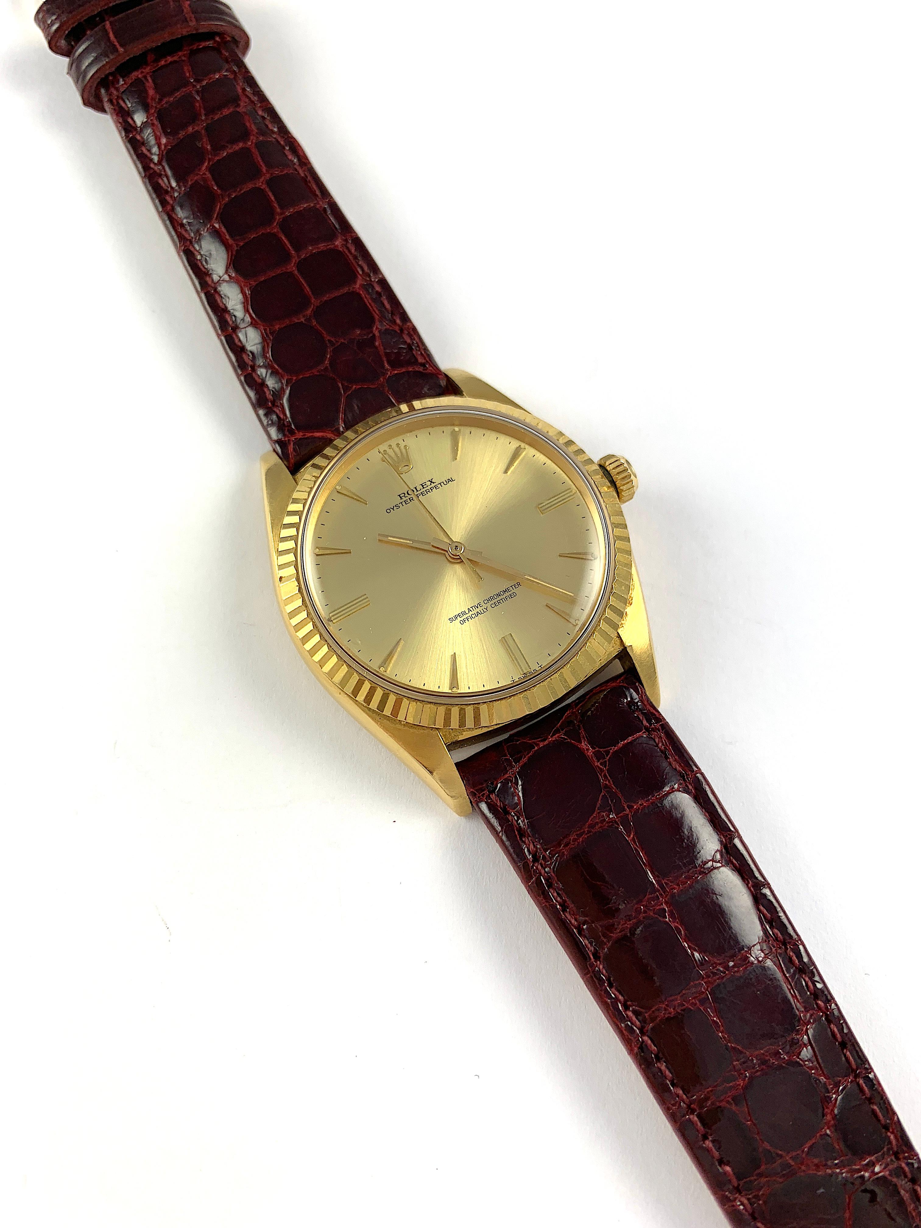 Rolex 18K Yellow Gold Oyster Perpetual  Automatic Watch
Rare Factory Champagne T Swiss T Dial with Unusual Hour Markers
Yellow Gold Fluted Bezel
18K Yellow Gold Case
36mm in size 
Features Rolex Automatic Chronometer  Movement 
Acrylic Crystal
From 
