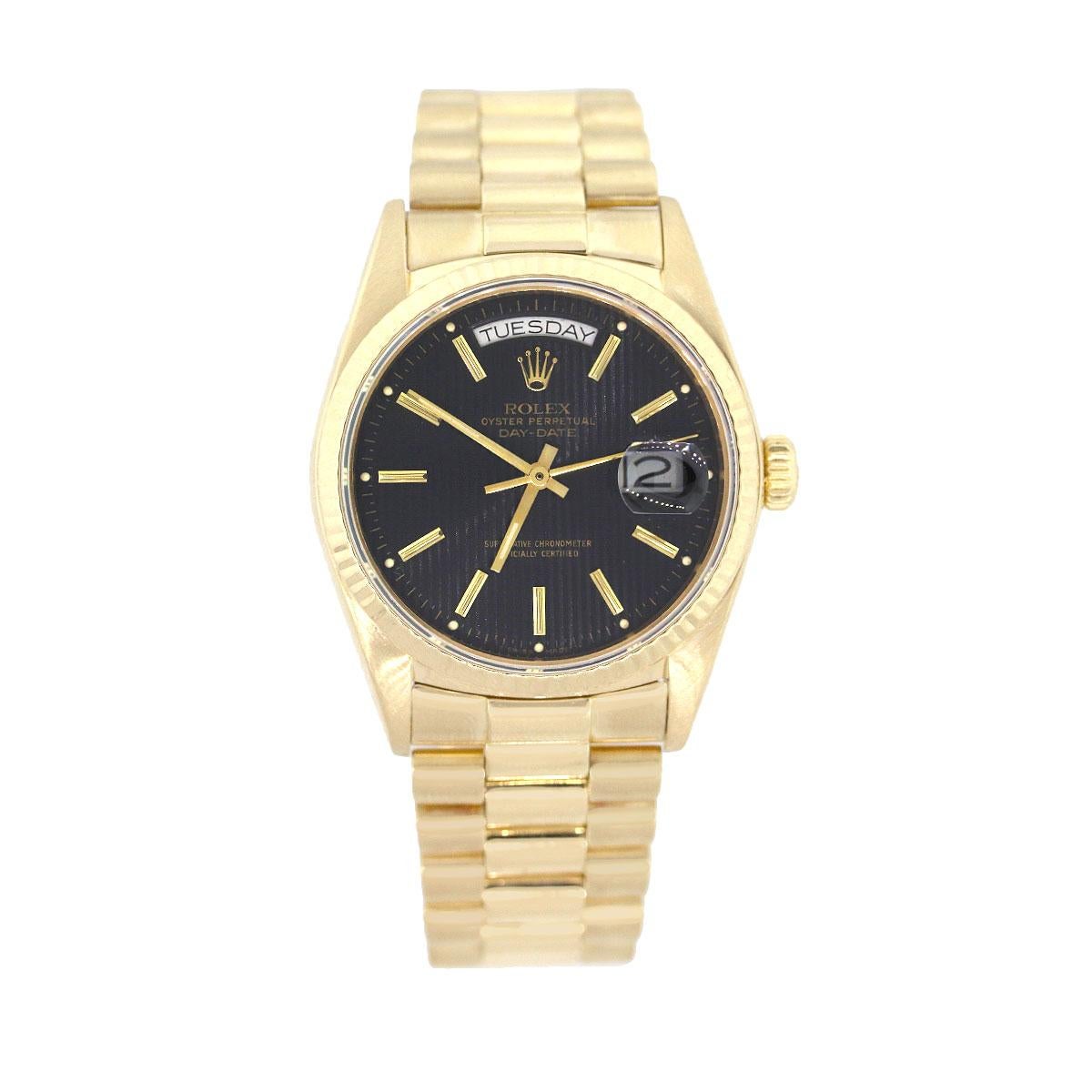 Brand: Rolex
MPN: 18038
Model: Day Date
Case Material: 18k yellow gold
Case Diameter: 36mm
Crystal: Plastic 
Bezel: 18k Yellow Gold fluted bezel
Dial: Black Tapestry textured dial with golden hands and hour markers. Date can be found at 3 o’Clock