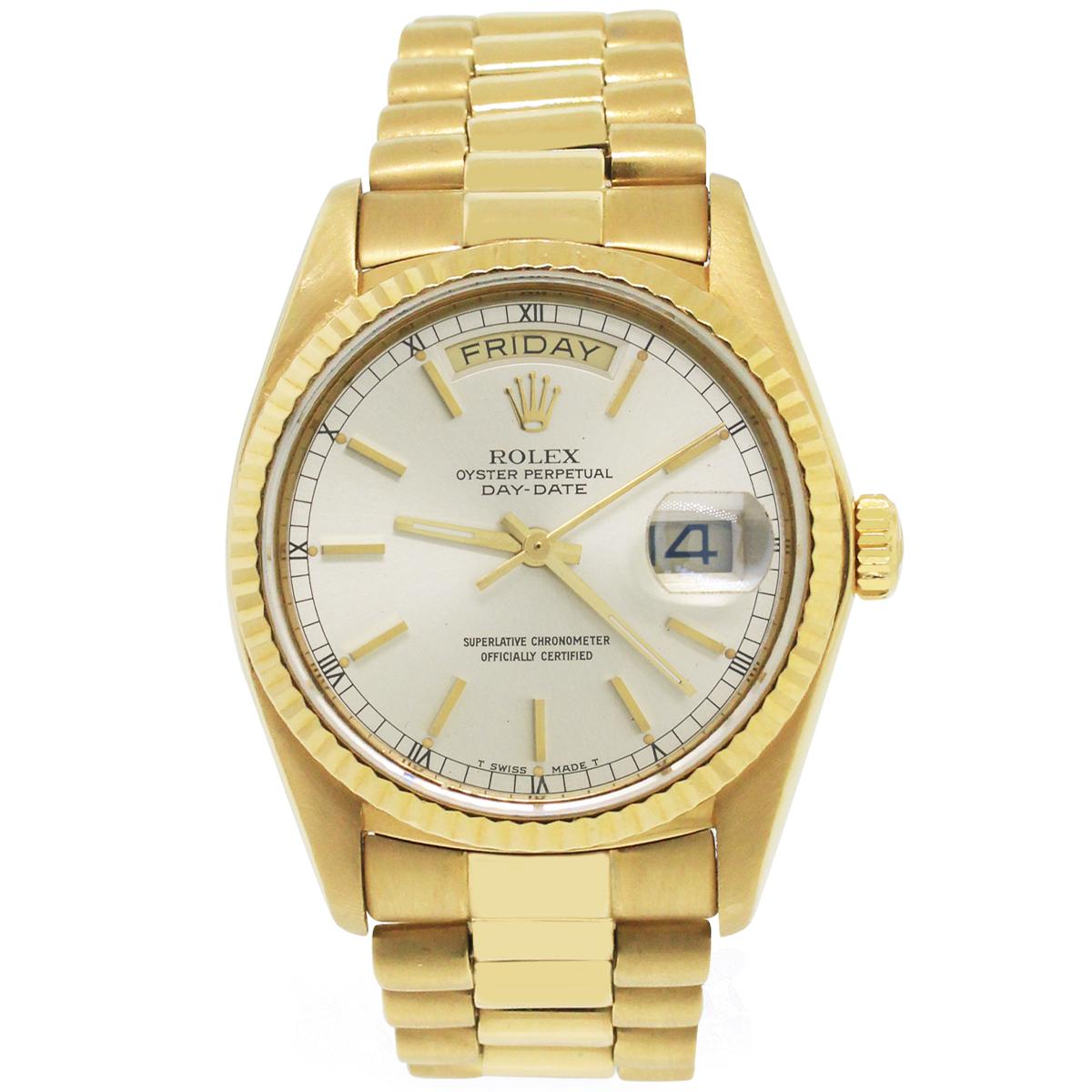Brand: Rolex
MPN: 18038
Model: Day-date
Case Material: 18k Yellow Gold
Crystal: Crystal
Bezel: 18k Yellow Gold Fixed fluted bezel
Dial: Silver dial with yellow gold hour markers and hands. Date is displayed at 3 o' clock. Day is displayed at 12 o'