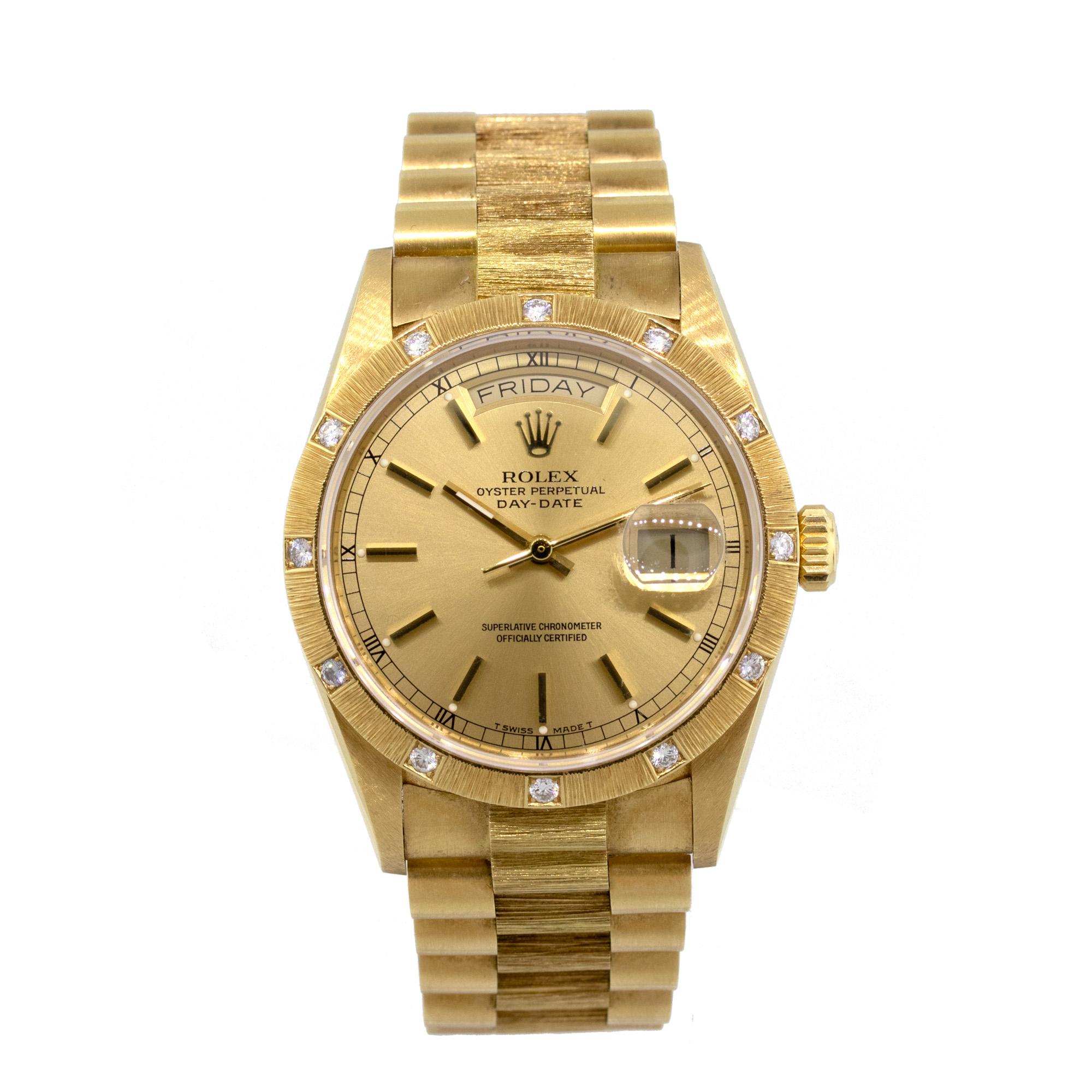 Brand: Rolex
MPN: 18108
Model: Day Date
Case Material: 18k yellow gold
Case Diameter: 36mm
Crystal: scratch resistant sapphire
Bezel: 18k yellow gold bark finish with factory Diamonds
Dial: Champagne dial. Date can be found at 3 o’Clock as well as