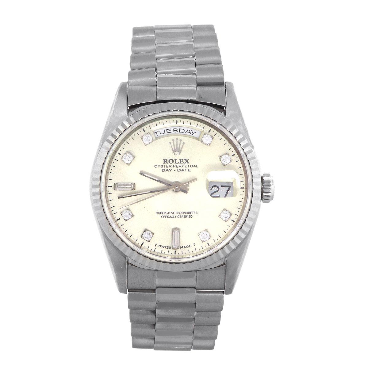 Brand: Rolex
MPN: 18239
Model: Day-Date
Case Material: 18k White Gold
Case Diameter: 36 mm
Crystal: Scratch resistant sapphire
Bezel: White Gold Fluted Bezel
Dial: Off white (Aging) dial with silver hands and diamond markers. Day can be found at 12
