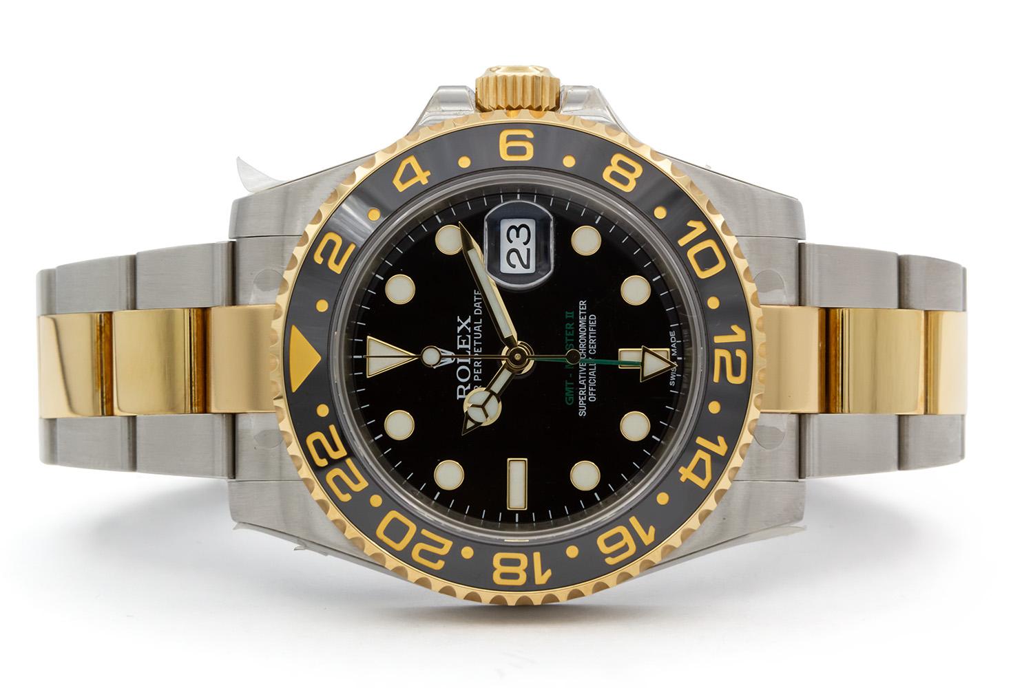 We are pleased to offer this excellent condition 2009 Rolex Two Tone GMT Master II 116713 which still has most of the original protective stickers on the case and bracelet. It features a 40mm stainless steel case with black dial, 18k yellow gold